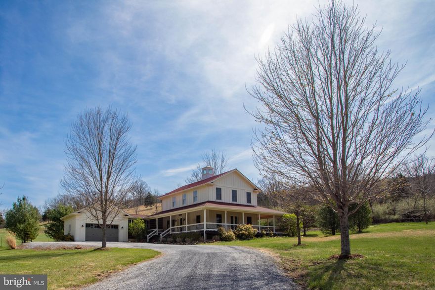 This exquisite architecturally designed farmhouse offers a blend of luxury and comfort, set against a backdrop of breathtaking mountain and pastural views. Sitting on 3.37 acres, this home invites you to experience an exclusive lifestyle defined by elegance and tranquility. Step inside to discover an open floor plan seamlessly connecting indoor and outdoor living that creates an inviting atmosphere perfect for both entertaining and everyday life. The gourmet kitchen is a chef's dream, featuring stainless steel appliances, and a spacious island that encourages culinary creativity. The family room has a cozy propane fireplace that serves as a warm retreat with large windows that bathe the space in natural light. The primary bedroom features a bathroom with both a soaking tub and a walk-in shower as well as a sitting area with fireplace and private balcony for ultimate relaxation. Additional interior highlights include convenient main floor laundry room, mudroom off of the garage and ample storage solutions, ensuring that every need is met with ease. The home is furnished with tasteful decor, allowing you to move in and immediately feel at home. Outside, the charm continues with a covered wrap-around porch which is partially screened offering the best of outdoor living. This property is not just a home; it's a lifestyle. Whether you're sipping coffee on the porch, hosting a barbecue, or simply soaking in the picturesque surroundings, this residence offers a unique opportunity to embrace a life of luxury and comfort. Experience the perfect blend of elegance and warmth in this exceptional home, where every detail has been thoughtfully curated for your enjoyment. Come and see what Lost River Living is all about.