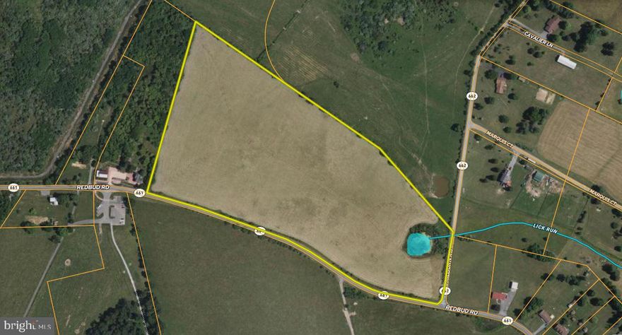 Positioned on the north side of Winchester, this parcel sits in a prime industrial and logistics corridor. Prominent neighbors such as GEODIS, Kraft Schenker Distribution Center, Monoflo International, Green Bay Packaging, Miller Milling Company, and the BWI4 Amazon Fulfillment Center underscore its strategic location. The property is currently zoned Rural Agriculture (RA) and is already designated Industrial in the County's adopted Comprehensive Plan, which supports and assists in the rezoning process.

The site offers dual road frontage on two state-maintained roads — paved frontage on Redbud Road and additional frontage on Milburn Road, which is scheduled for VDOT asphalt paving in 2026.  The new VDOT road (Norman Drive) will run along the northern boundary, creating a third point of access. The property is located minutes from Interstate 81, Route 11, and the 37 Bypass.

Utilities are easily accessible, with water and sewer mains within 500 feet and on-site electricity service lines. The nearly flat, cleared land enables cost-effective and straightforward development.