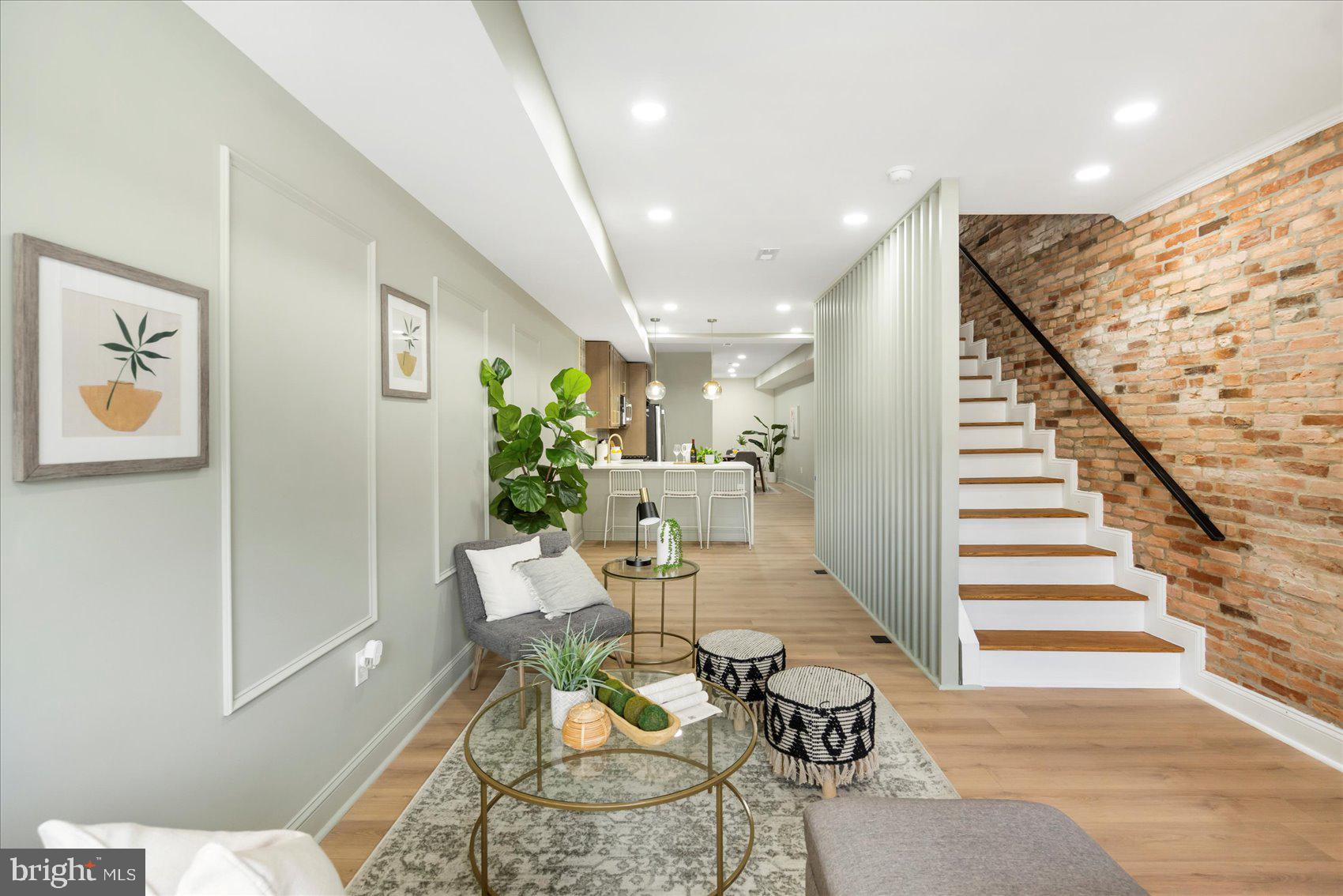 Beautifully remodeled 3BR/3.5BA Townhome located on a tree-lined street in the heart of Station North. Make your way to the front door and step into your forever home. Step into a home filled with natural light, an open concept floor plan, custom moldings, a soft color palette, and luxury flooring. The main floor offers a large living room, stunning kitchen and spacious dining room. The kitchen features plenty of cabinets with gold accents, stainless steel appliances, a deep stainless sink, and a large peninsula with pendant lights and seating for three. On the second floor is a half bath, the convenience of second floor laundry, a spacious secondary bedroom with a private full bath, a larger secondary bedroom with a full bath offering a walk-in shower. On the third level is a private owners suite boasting a private en suite offering a large walk-in shower. The lower level is finished offering additional living space featuring a large family room, utilities, and storage. From the dining room, step outside to a newly fenced yard with a large patio and tons of possibilities. This home is move-in ready with so much to offer new homeowners and is located in close proximity to shopping, restaurants, and commuter routes.