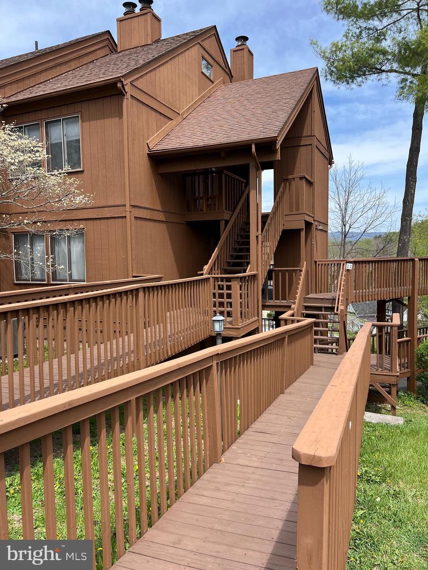 This is not a typical "As Is" condo at The Hill. An experienced, licensed contractor has done the hard part, now it's your turn to add your own touches. Choose the perfect counter tops, appliances and other touches to make it truly yours. There is beautiful laminate flooring in the great room, Hall and bedroom. You'll find elegant tile in the kitchen and bath. The tankless hot water system makes the walk-in tile shower possible. In short, this weekend retreat or rental needs your decorator's eye to complete the job and then, just sit back and enjoy the view from the great room or deck. And, yes, winters are cozy and inviting with the woodburning stone fireplace. You'll be a short walk to Lake Laura and the Community Store as well, as two area favorite restaurants. Or, enjoy the 5 minute drive to Bryce's main lodge, golf course, mountain biking and outdoor water park for members. The Resort has so much to offer and is just 90 minutes to two hours from DC and Richmond. Hurry, check out this great opportunity! (((Please note: the lumber and finishing items in the unit will convey, but the construction equipment, if any, will not convey.)))