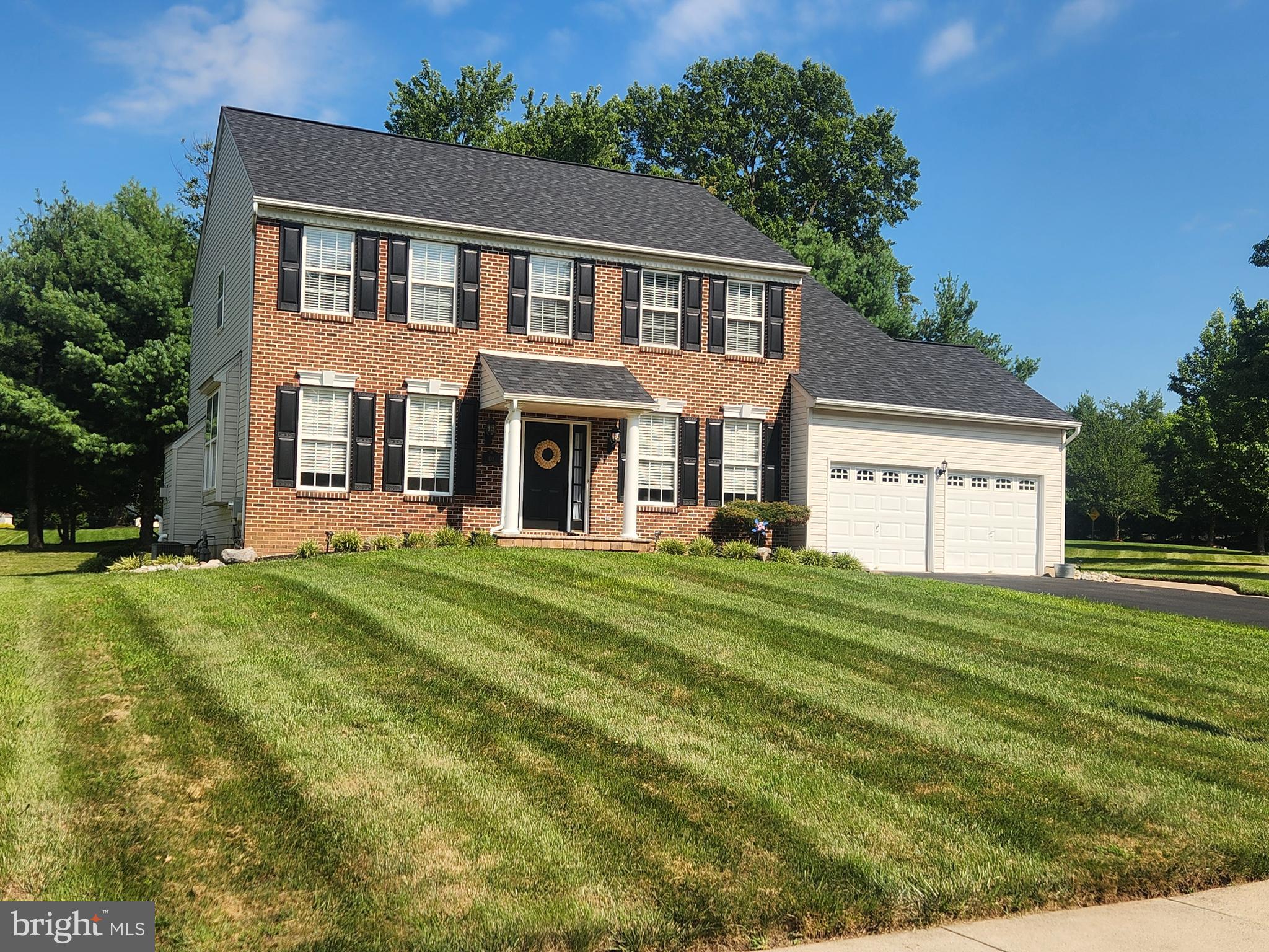4 Bedroom, 2.5 Bath full brick front, 2-story Colonial in Redstone Woods that features a 2-story Foyer with hardwood floors that continue into the formal Living rm, Dining rm & eat-in Kitchen. The Kitchen offers a center island & an eating room with a slider leading to a custom hardscape patio. Kitchen opens to the Family room with fireplace. 1st floor Laundry rm & powder room. 2nd level features a Primary BR w/ sitting room, 2 large closets & primary bath with double vanity, corner tub & separate shower. 3 additional roomy bedrooms & full hall bath. 2 car Garage, full Basement.