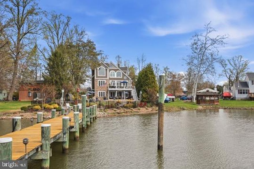 Welcome to this exceptional Coastal Contemporary Craftsman in the sought-after waterfront community of Harewood Park in Middle River. Rated one of the friendliest neighborhoods with a strong sense of community, a golf cart-friendly lifestyle, and water views, Harewood Park is often considered a hidden gem where neighbors connect, sunsets become part of daily life, and the pace feels just a little easier. This is an amazing neighborhood with a voluntary association that organizes local events.  
 
From the moment you step inside, this home makes an impression. A charming powder room near the entry has its own character, while the main living space immediately draws your eye to the stunning water views. Designed for both everyday living and entertaining, the open-concept main level features vaulted ceilings, transom windows, a striking stone gas fireplace, and hand-scraped engineered mahogany hardwood flooring. The chef’s kitchen offers a large island, soft-close cabinetry, beautiful stonework, a 6-burner Dacor professional stove, wine refrigerator, coffee bar, and a separate dining area with wood beam ceilings. French doors lead to a spacious deck overlooking the heated in-ground saltwater gunite pool and expansive waterfront setting. The main level also includes two generously sized bedrooms and a full bath with walk-in shower and laundry. 
 
Upstairs, the primary suite is a true retreat with double-door entry, tray ceiling, sweeping water views, private office space, and a loft/media nook. The spa-like primary bath features dual vanities and a jacuzzi tub, creating the perfect place to relax. Additional highlights include an integrated sound system, custom lighting, two-zone HVAC, tankless water heater, and two 200-amp electrical panels. 
 
Outside, waterfront living takes center stage with a 100-foot pier offering water and electric, space for multiple boats, and a separate kayak launch. A 2-car garage with epoxy floors and thoughtfully designed outdoor living areas complete this remarkable property. More than just a home, this is a true waterfront lifestyle.