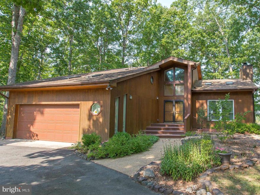 Unique Contemporary Home in Lake of the Woods! Vaulted ceilings, skylights, large windows create open and airy ambiance to this special 3 BR/2 BA home in recreational community. Well-Maintained situated in quiet, private setting, perfect for entertaining and enjoying life to its fullest. Main living hardwood floors, large kitchen, multi-tiered deck, sunroom, spacious Master Suite; MUST SEE!