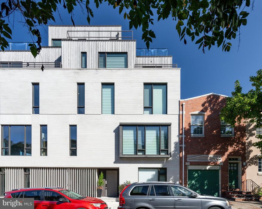 2531 Pine is not just a home - it's a lifestyle.  This 30-foot-wide bespoke townhouse in the coveted Fitler Square neighborhood maximizes space and style, offering refined rooms perfect for both grand entertaining and quiet moments. From the 3-car garage, elevator to all levels, home theater, smart home integration, and 3 outdoor spaces, every detail has been considered.

Designed for discretion, the entryway is intimate and refined, with paneled walls concealing a handsome office. Custom built-ins for coats and a hall bathroom are an added convenience on this level. The stunning centerpiece of this home is the second level, which opens into an epicurean kitchen with top-tier appliances, an 8-foot island with Dekton countertops, and a balcony equipped for grill masters. Built-in media, sound systems, and a sleek fireplace elevate casual evenings and elaborate entertaining. A powder room is also located on this level. The third level offers a central lounge, three spacious guest bedrooms with two full bathrooms, a well-appointed laundry room, and a built-in linen closet. The fourth-floor Primary Suite is a sanctuary of calm, complete with a lavish en-suite bathroom with a soaking tub and shower center, dressing room, kitchenette, and a private balcony.

The expansive roof terrace provides panoramic city views, an outdoor kitchen, surround sound, and a six-person hot tub with customizable jets for the ultimate hydrotherapy experience. The lower level offers the ultimate city living experience with a home theater, wet bar, and fitness center, all with heated flooring.  Additional amenities include multi-zoned 6-system HVAC, radiant heat flooring, built-in security cameras, motorized window treatments throughout, and custom millwork & built-ins.

2531 Pine Street is part of Fitler Four - a luxury townhouse development with a gated driveway and a complete 10-year tax abatement. Located just off the Schuylkill River Park, this premier location offers easy commuting to Penn, CHOP, 30th Street Station, and PHL International Airport, and is nearby to local shops and acclaimed restaurants.
