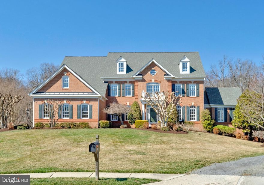 Exceptional estate home in sought-after Virginia Run, beautifully sited on nearly an acre backing to serene parkland at the end of a quiet cul-de-sac. This Stanley Martin built residence offers over 7,000 sq ft of living space, featuring six bedrooms with en-suite baths and a fully finished walk-out lower level designed for both entertaining and comfortable everyday living. Homes offering this level of space, privacy, and parkland views are rarely available in Virginia Run.

A dramatic two-story foyer with a sweeping curved staircase sets the tone, opening to elegant formal living and dining rooms enhanced by soaring ceilings and abundant natural light. The main level also features a spacious morning room, a conservatory, and an impressive two-story family room anchored by a gas fireplace. A wet bar conveniently located just outside the conservatory enhances the entertaining flow.

The kitchen is appointed with maple cabinetry, granite countertops, a walk-in pantry, and a center island with a new GE gas cooktop (2026). It opens seamlessly to both the morning room and a spacious deck overlooking the lush, private backyard. A main-level bedroom suite with full bath provides ideal flexibility for guests, multigenerational living, or a private home office. A secondary rear staircase leads from the kitchen to the upper level, where the wide hallway offers wooded views across the back of the home.

Upstairs, the luxurious primary suite serves as a serene retreat with a sitting area, tray ceiling, generous walk-in closet, and a renovated spa-inspired bath featuring a soaking tub, glass-enclosed shower, dual vanities, and a private water closet (2017). Three additional upper-level bedrooms each enjoy direct bath access, ensuring comfort and privacy for family or guests.

The fully finished walk-out lower level is thoughtfully designed for recreation and entertaining, featuring a bar, expansive game and gathering areas with a gas fireplace, direct access to the private stone patio, and an additional bedroom suite.

Extensive updates include: roof (2023), water heater (2022), fresh interior paint (2026), exterior paint (2025), new GE gas cooktop (2026), hardwood flooring added in the primary bedroom (2017), new carpet in two upper-level bedrooms, upper-level bath refresh (2026), and driveway resealed (2025).

Outdoor living is exceptional, with two decks, a stone patio, irrigation system, professional landscaping, and mature trees creating a peaceful, park-like setting. The flat backyard offers both privacy and usable outdoor space, ideal for entertaining, play, or quiet relaxation.

Located within the sought-after Virginia Run community, residents enjoy access to a pool, tennis and pickleball courts, clubhouse, and scenic walking trails, all conveniently close to Routes 28, 66, and 50, as well as Washington Dulles International Airport.