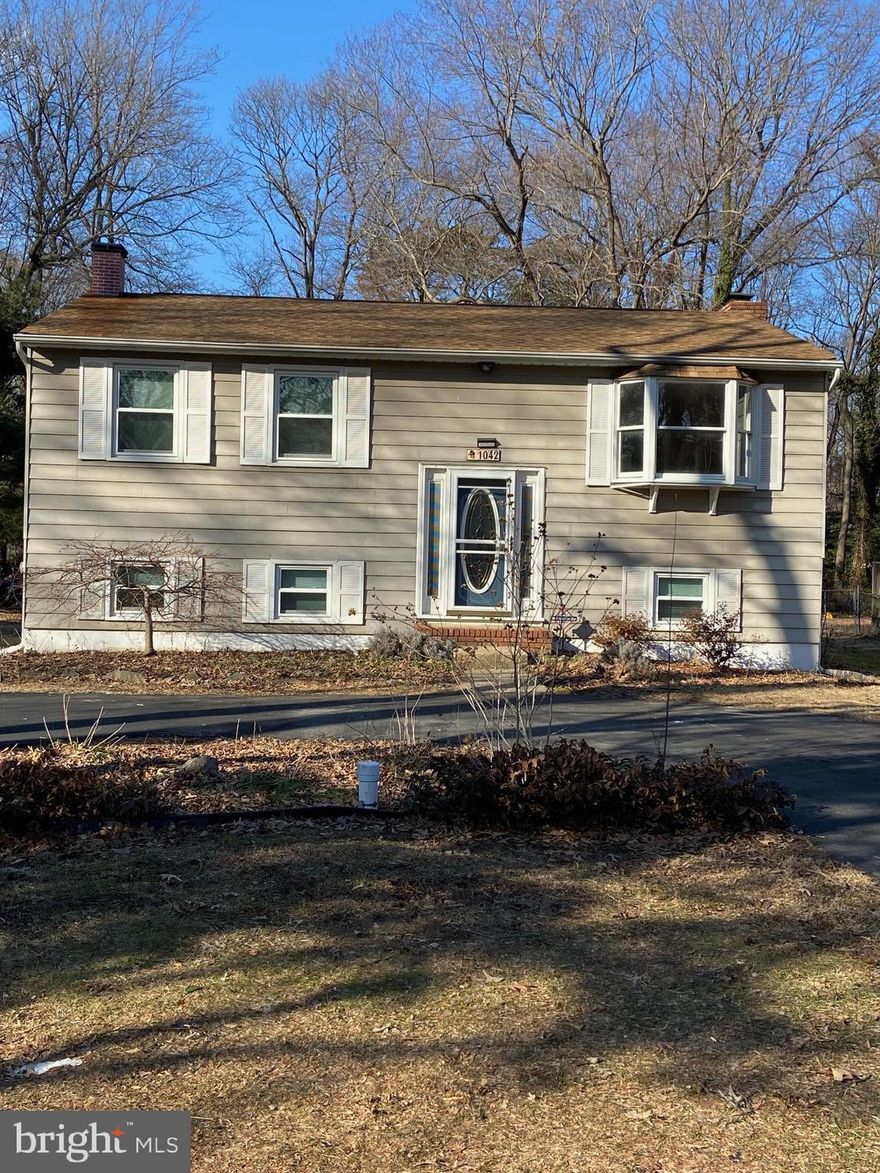 Welcome to 1042 Dockser Drive in the water privileged community of Arden on the Severn.  This home features new carpet and fresh paint throughout.  Upper-level primary suite has large dressing/sitting area with multiple closets and an en-suite half bath.  Kitchen boasts granite counters and tile backsplash with stainless steel appliances. Living room with sunny bay window.
 Lower-level family room features a cozy brick fireplace with a wood-burning insert. Bonus third room for den/office or extra bedroom.  Large Utility room with washer/dryer connections, large water heater, French drain system and sump pumps. 
Expansive deck overlooks large backyard.  Large storage shed and concrete patio.  
Community amenities include Arden beaches, boat ramps and piers plus Community ball fields and playgrounds.