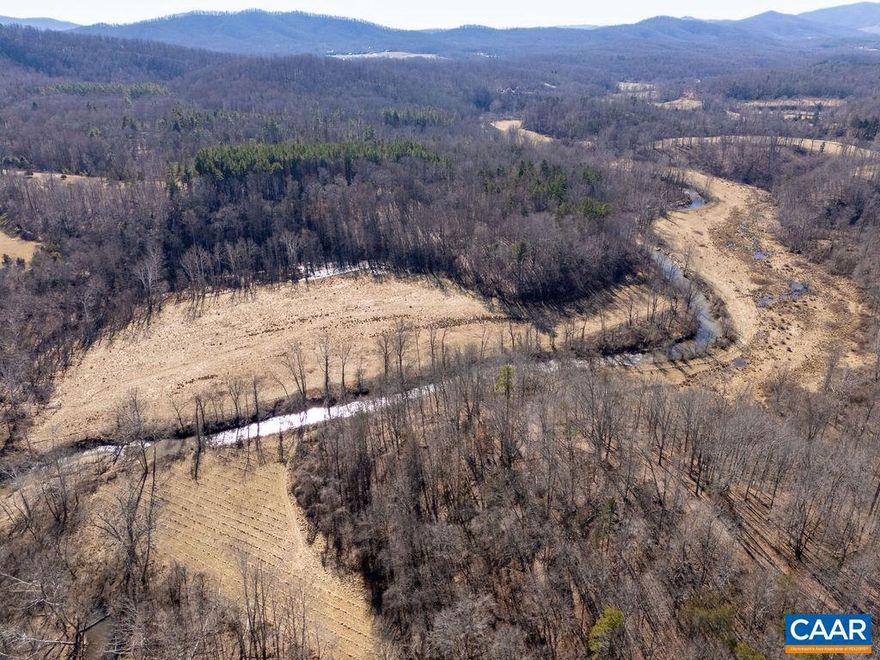 Idyllic 87 acre riverfront property with elevated building sites in Western Albemarle. Currently under preferred land use taxation, this noteworthy property has 13 theoretical division rights making it a possible candidate for conservation easement. A remarkable opportunity to build close to town while enjoying unrivaled privacy. Located between Ivy and Crozet just 5 minutes to shopping, 10 minutes to vineyards and breweries, 17 minutes to UVA, and 20 minutes to Downtown Mall. An oasis for nature lovers and outdoorsmen with forest, meadows, and over 3000 feet of frontage on the Mechums River. A rare opportunity to have this amount of acreage in such a coveted location with the potential for both water and mountain views.