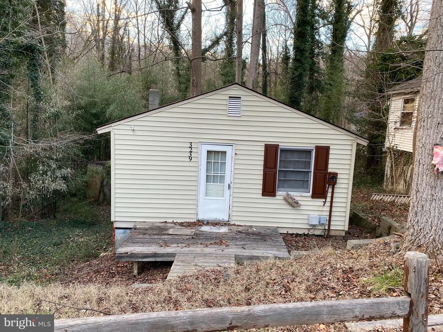 Tiny House living possibilities! This home is located in a great waterfront community with a community beach and pier. Property backs up to the American Chestnut Land Trust property.  Home needs some work.  Lower level has some organic growth near the front of the house.  Sold strictly in 'as is' condition.    Come by and see if this could be your new tiny house!