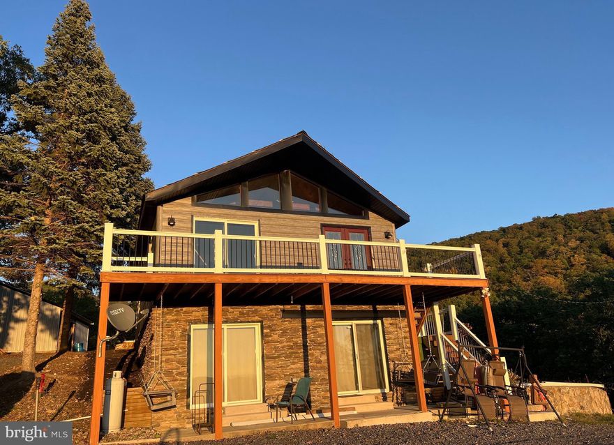 This cabin is uniquely perched atop a small knoll on the side of High Knob, to afford the panoramic vista of the valley below and the rolling hills all the way to the Allegheny Front! Absolutely breathtaking sunsets from the deck! Sitting on almost eighty acres,  with a community pond below, trails around the entire mountain and to the river on the back side, there is never a loss for outdoor recreation. There are excellent hunting opportunities, ATVing, target practice, hiking and more! Canaan Valley, for skiing, is just a little over an hour away. Kayaking, fishing, golfing, restaurants, movie theatre and more within minutes! Just two hours from NOVA, this cabin makes the perfect weekend getaway or make it your full time home in the woods with no neighbors in sight! There  are plenty of other build sites and there is  public water and fiber optic available at the bottom portion of the property.