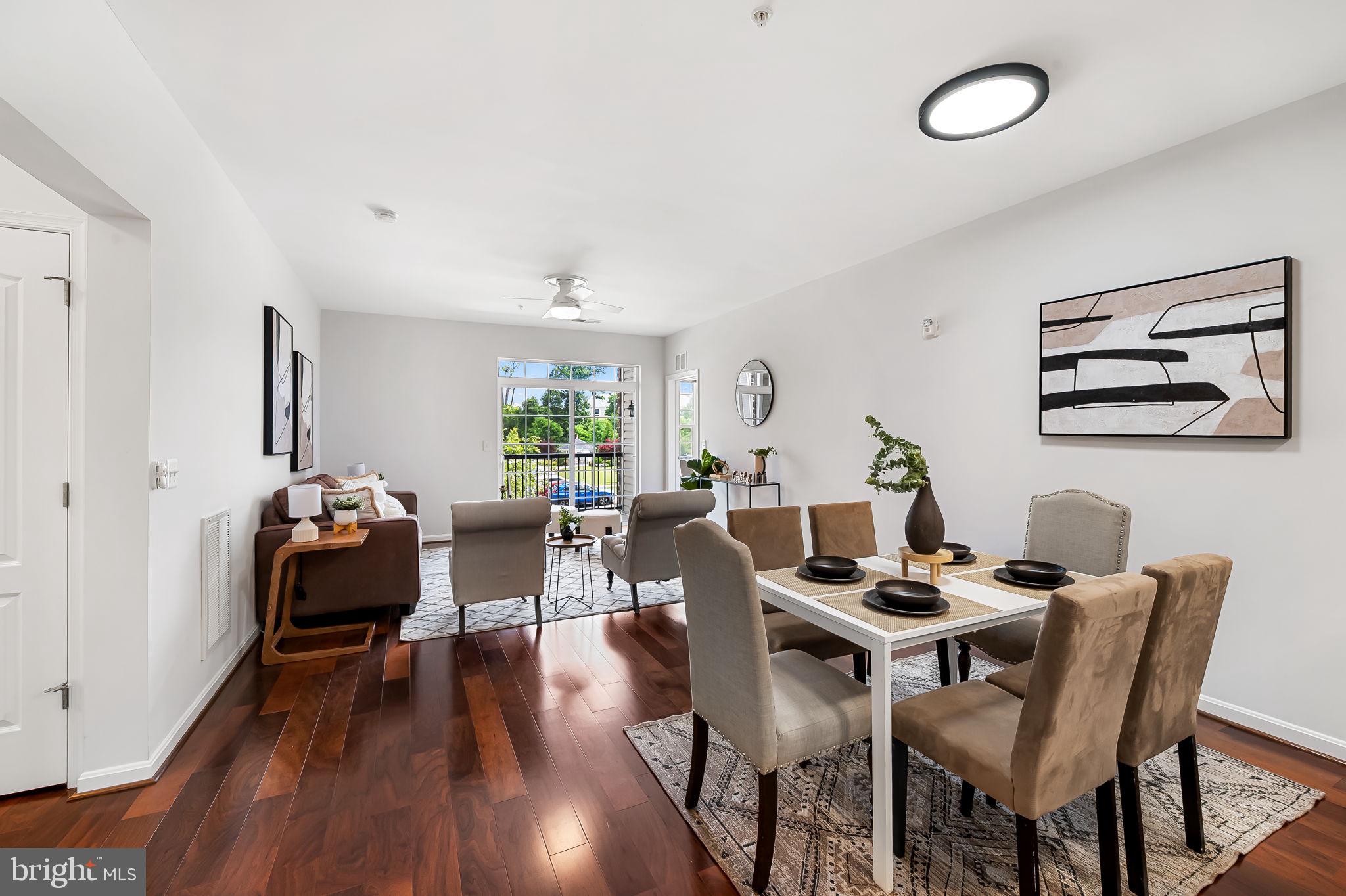 Welcome to The Gatherings at Quarry Place, a premier 55+ community where lifestyle meets comfort. This beautifully crafted condominium offers 1,355 square feet of thoughtfully designed living space, including 2 spacious bedrooms, 2 full baths, and a detached 1-car garage. Ideally located against the peaceful backdrop of a scenic quarry lake, this home pairs modern conveniences with serene, natural surroundings. Inside, an open-concept layout invites you in with gleaming hardwood floors, recessed lighting, and abundant natural light throughout. The chef-inspired kitchen is both stylish and functional, featuring stainless steel appliances, a gas range, crisp white cabinetry, subway tile backsplash, and generous counter space. A peninsula breakfast bar seamlessly connects the kitchen to the airy living area, which flows onto a private balcony—perfect for savoring your morning coffee or enjoying tranquil courtyard views. Just off the entryway, a dedicated laundry room offers everyday convenience. Both bedrooms are generously sized with plush carpeting and excellent closet space. The primary suite is a peaceful retreat, complete with a sunny sitting area, dual closets—including a walk-in—and a luxurious ensuite bath. Enjoy spa-like features such as dual vanities, elegant tilework, and an oversized walk-in shower with a built-in bench. Residents of The Gatherings at Quarry Place enjoy access to an array of resort-style amenities, including a clubhouse with a fitness center, an outdoor pool and hot tub, grilling stations, and sunbathing areas, this unit even has a storage unit! Meandering lakeside trails, community gardens, and expansive green spaces add to the charm and vibrancy of this active adult community. Conveniently located just minutes from Foundry Row Shopping Center, the MARC train station, and I-795, this home offers the perfect balance of accessibility, comfort, and elevated 55+ living.