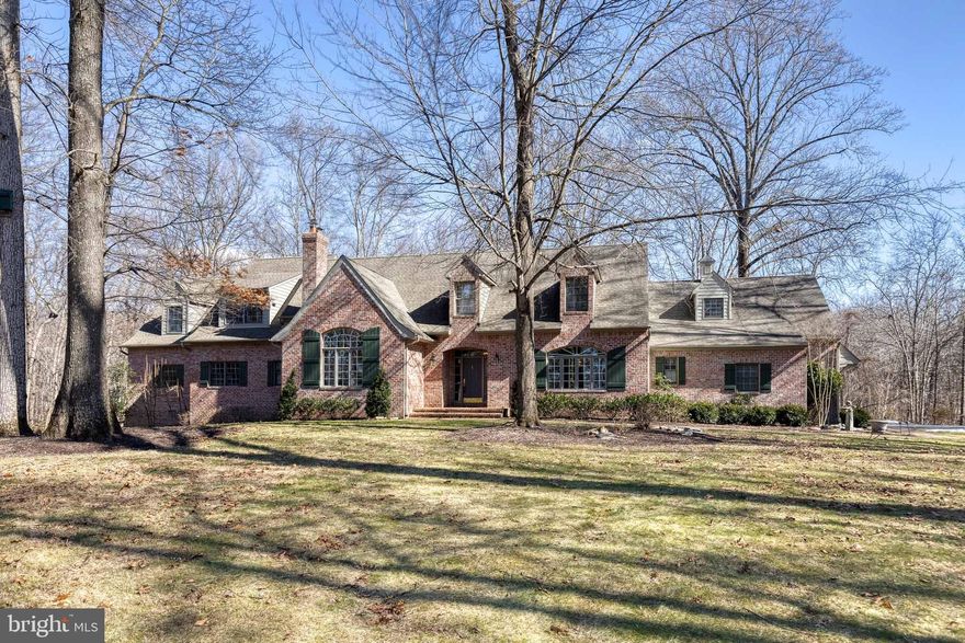 Welcome to 13509 Narrow Leaf Ct, a thoughtfully designed and impeccably maintained custom home in sought-after Clarksville. Built by the original owner, and nestled on a private 3.87-acre lot, this stately residence offers the perfect blend of craftsmanship, comfort, and convenience. As you step inside, you’re greeted by a grand foyer featuring a custom double-paned window as a focal point, setting the stage for the home’s exceptional detail. The main level is designed for effortless living, with a spacious kitchen featuring granite countertops, an eat-in area, and a large pantry. The adjacent breakfast room and family room provide a warm, inviting space with crown molding, and a fireplace, an ideal spot for morning coffee or evening relaxation. The dining room boasts built-in cabinetry, elegant molding, and generous natural light, while the living room offers a cozy retreat with soaring ceilings with exquisite architectural flourishes and a wood-burning fireplace. The primary suite, also on the main level, features new carpeting, a built-in closet system, and private access to the screened porch for a peaceful escape. The huge en-suite bath is well-appointed with a soaking tub, heated towel rack, and supplemental electric heater for added comfort. Upstairs, four spacious bedrooms, three full bathrooms (two of the bedrooms have en-suite bathrooms), and a built-in bookcase at the landing provide ample space for family or guests. One of the bedrooms includes a wet bar and washer and dryer, offering additional flexibility. The main level also features a workshop adjacent to the three-car garage, and a laundry area. High ceilings and built-in storage make this space as functional as it is expansive. The lower level includes an exercise room, a utility area, and plenty of unfinished space with high ceilings for future options.  Quality craftsmanship is evident throughout, with radiant heated flooring, meticulous upkeep supported by multiple service contracts, and a whole-house reverse osmosis system ensuring high water quality. Recent updates include a ***newly paved driveway (2019), ***sidewalk (2018), and mechanical upgrades such as a ***water heater and storage tank (2019)  ***air conditioning system (2016). Conveniently located near River Hill Village Center, Schooley Mill Park, and major commuting routes to APL, NSA/Ft. Meade, MARC trains, D.C., Baltimore, and BWI; this home offers privacy without sacrificing accessibility. If you’re looking for a home that balances elegance with everyday comfort, 13509 Narrow Leaf Ct is ready for you. Schedule your private showing today.