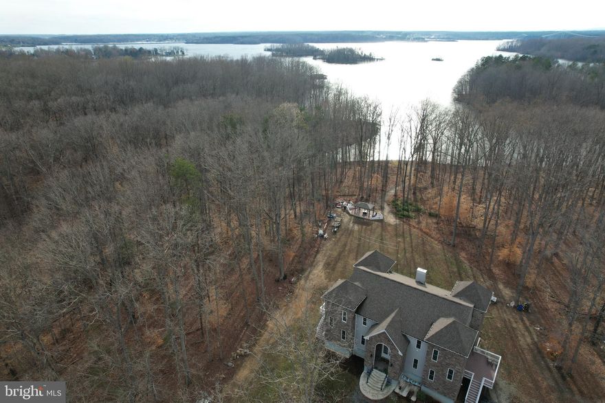 Embrace the allure of living at the Lake View Castle Retreat with LAKE ACCESS, a splendidly renovated home with everything NEW offering a captivating blend of modern comforts and scenic beauty. This huge lake castle like home constructed with 2”X6” framing roughly 7, 000 sq ft, boasting SIX (6)+ bedrooms and five and half (5.5) baths are waiting for you. This lake view castle easily accommodates 16+ guests or two families/in-law suite, making it an ideal destination for families and friends seeking an immersive lake castle life experience. The luxurious Lakeview Master Suites, every corner of the house with open floor plan exudes comfort and style. Step into the heart of the home—the kitchen with NEW Stainless-Steel Appliances, a space that invites culinary delights. Stepping into the great room has a 24 ft ceiling with 6 professional massage chairs/couch with the huge TV for family entertainment provides a warm and inviting atmosphere, creating the perfect setting for relaxation and shared moments. From there, step outside to the outdoor play area, where the charm of the lake castle extends to nature-filled spaces, promising endless joy for both children and adults. THREE (3) NEW huge decks and a HUGE PATIO with an ENORMOUS VIEW of the LAKE is a PARADISE!  Lake access becomes an integral part of the Lake Castle Retreat experience. Launch boats, jet skis, or kayaks just minutes away from High Point or Anna Point ramps, unlocking a world of water adventures. Revel in the beauty of the MAGNIFICENT WATERVIEW, a one-of-a-kind spectacle that adds to the allure of this lakeside haven. Positioned conveniently, the Lake Castle Retreat is a mere 30 minutes from King Dominion Amusement Park and a short 1.5-hour drive from Washington DC or MGM Casino/National Harbor, Tyson Corner Mall, making it an accessible and attractive destination for leisure and shopping. As the day unfolds, savor the breathtaking views and sunsets on the enormous deck with loved ones. Whether swimming, fishing, or roasting marshmallows by the fire pits, the property provides an array of recreational activities. Venture into the wooded areas to explore wildlife, creating unforgettable memories in the heart of nature. Wait! step down to the newly finished basement/man cage with full kitchen, wet bar, pool table, professional poker table for late night entertainment. Are you prepared to embark on a memorable journey at Lake Castle Retreat?  Let every moment become an opportunity to build cherished memories.  Perfect for VACATION HOME OR SHORT TERM RENTAL!

1, Custom and newly renovated throughout all levels with open floor plans 10ft-24ft ceilings

2. new kitchen appliances for both kitchens

3. all new 5.5 bathrooms 

4. 2 master suites bedrooms plus 2  bedrooms  in upper levels and option of two (2) additional bedrooms in the basement

5, massage chairs in great room for entertainment

6, 3 new decks and a boat patio for outside entertainment

7. New 6" gutters are in the work of replacement

8. soil study was done for additional bedrooms as needed (can be expanded to 6 bedrooms) see soil study records attached.

9. Electric car charger installed 

10. Top of the line Jetski 2019 Seadoo GTX 300 with less than 50 hours and 2017 Yamaha Jetski with less than 90 hours on a newly installed assigned slip.  These are available for sale as a package deal as well. 

11. All furniture and entertainment equipment  inside the house are available for the full package deal as well. 

12. Built in 2017 with 4.17 Acres with back to water and trees