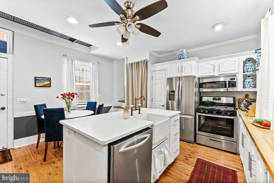 Located on a picturesque tree-lined block in the heart of Rittenhouse Square, this sun-filled 2-bedroom, 1.5-bath trinity blends classic Philadelphia charm with modern comfort, thoughtful updates, and flexible living space. With both north and south exposures, the home enjoys beautiful natural light throughout the day. The updated kitchen is designed with both style and function in mind, featuring white shaker cabinetry, butcher block countertops, a custom white quartz island, farmhouse sink, gas cooking, stainless steel appliances, pantry storage, and a built-in spice rack. Just off the kitchen, a private yard offers a rare outdoor retreat in the city, ideal for morning coffee, evening dining, or warm weather entertaining. The second level is bright and versatile, currently styled as living space and enhanced by a built-in Murphy bed for added flexibility. This floor also includes a full bath with Carrera marble, tub, linen closet, and a stackable washer and dryer with additional storage. The top floor is arranged as the primary suite, complete with an en-suite half bath, exterior vanity area, three spacious closets, and blackout cellular shades for added comfort. Wide-plank cypress hardwood floors extend throughout, adding warmth and continuity to the home’s thoughtfully designed interior. Located just steps from Rittenhouse Square and one block from South Street, the home offers easy access to neighborhood favorites including Rex at the Royal, La Sera Italiana BYOB, and Bistro SouthEast, along with nearby public transportation and all the energy of Center City. Bright, refined, and exceptionally well located, this is city living at its best.