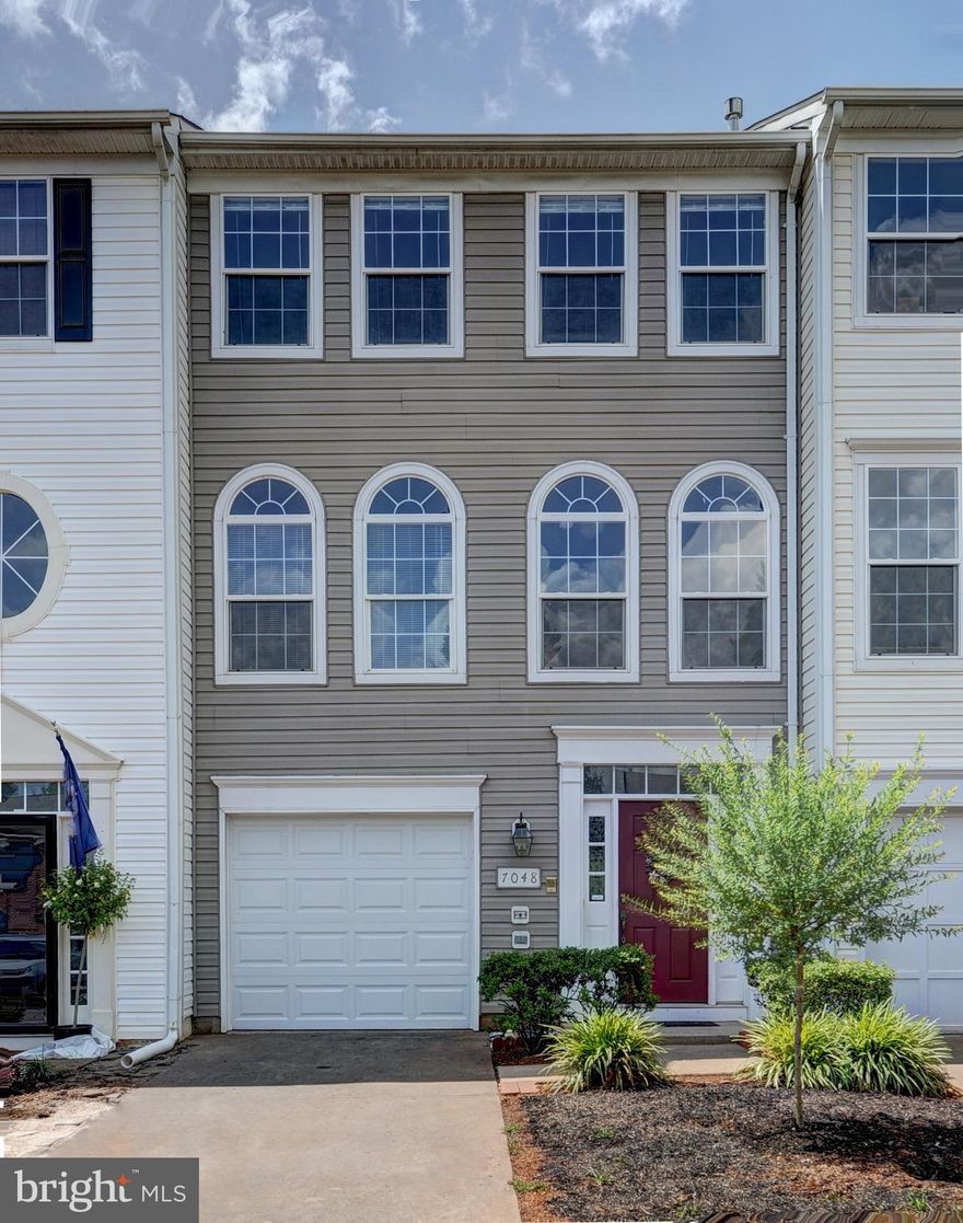 Nestled within the Greenhill Crossing community and just steps from old town Haymarket, this sun-drenched townhome is move-in ready! Featuring 3 bedrooms and 3 full baths, this home is east facing and lets in tons of natural light. Sunlight pours through the wall of windows in the family room. Large eat-in kitchen with an island walks out to the wood deck overlooking a fully fenced backyard and huge, mature tree. Master bedroom boasts a vaulted ceiling and large walk-in closet while the master bathroom offers a soaking jacuzzi tub and a separate shower. Fully finished garage with fresh paint and protective coating on the floor. Walkout basement has a full bath, new flooring, and a den that could be used as a possible 4th bedroom. Lots of updates throughout the home, to include floors, carpet, paint, bathrooms, and a new hot water heater. Just steps from old town Haymarket, shops, restaurants, and more. This walkable community offers a neighborhood pool, tennis and basketball courts, spacious clubhouse, exercise/ weight room, multi-purpose field, two village greens, a pond, and tot lot.