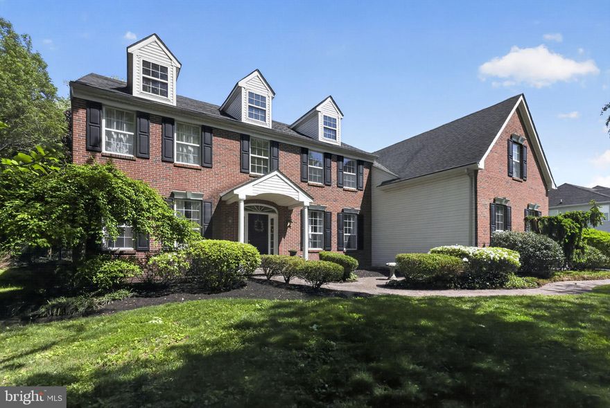 138 Barbara Drive presents an exceptional opportunity to own a spacious brick-front home in the desirable Wiltshire Glen community of Lower Makefield Township and the award-winning Pennsbury School District. Set behind a classic brick paver walkway, this 4-bedroom, 2.5-bath residence offers over 4,300 square feet of living space above grade, a partially finished basement, a 3-car side-entry garage, and a private fenced backyard with an inground pool. Step inside the dramatic two-story foyer where hardwood flooring, custom millwork, and elegant architectural details create a warm and welcoming first impression. Enjoy 9 ft ceilings on the entire first level. The formal dining room is accented with crown molding, chair rail detail, hardwood flooring, and decorative columns, creating an inviting setting for holidays and gatherings. A separate formal living room (currently being used as a billiards room) offers additional space for entertaining or quiet relaxation. The soaring two-story family room is filled with natural light from an abundance of windows and features recessed lighting, a wood-burning fireplace, and an adjoining bar room that makes the space ideal for entertaining. A dramatic curved balcony overlooks the family from the second floor hall. The kitchen offers wood cabinetry, double ovens, a center island with seating, huge walk-in pantry, recessed lighting, and a bright breakfast nook overlooking the backyard. Just off the kitchen is a sunroom with sliding glass doors leading to the rear deck and patio, creating a seamless connection to outdoor living and providing the perfect spot to relax and enjoy views of the backyard and pool. The main level also includes a powder room and laundry room with utility sink for added convenience. Upstairs, the spacious primary suite features a private sitting room, walk-in closets, and an ensuite bath complete with a jetted tub. Three additional bedrooms share a hall bathroom with double vanity. The partially finished basement provides versatile additional living space perfect for a home office, gym, media room, playroom, or guest overflow. Outside, the fenced backyard and inground pool create the perfect setting for summer entertaining, relaxing weekends, and outdoor enjoyment. Ideally located near Yardley Borough, Yardley Country Club, parks, shopping, dining, and major commuting routes, this home offers space, location, and tremendous potential in one of Bucks County’s most sought-after neighborhoods.