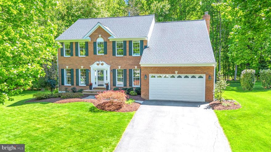 Welcome to this exceptional brick-front colonial, gracefully situated on over half an acre in a private double cul-de-sac enclave in the heart of Olney. Surrounded by lush landscaping and backing to serene wooded views, this meticulously maintained and extensively updated residence offers the perfect blend of elegance, comfort, and modern convenience. Step inside to a grand foyer adorned with beautiful oak hardwood flooring that flows throughout the main level, setting the tone for the home’s open and airy layout. To the left, a formal living room seamlessly connects to a refined dining room, ideal for hosting gatherings. To the right, a versatile flex space with French doors provides the perfect setting for a private home office or study. At the heart of the home is the fully renovated kitchen, thoughtfully designed with 42-inch white cabinetry, granite countertops, under-cabinet lighting, stainless steel appliances, and an expanded island with a built-in microwave and additional storage. A dedicated beverage center and coffee bar elevate the space for everyday enjoyment and entertaining. The kitchen opens to a bright breakfast area with picturesque views of the backyard and flows effortlessly into the inviting family room, centered around a cozy fireplace. Just beyond, an expansive sunroom filled with natural light offers a tranquil retreat or the perfect space for entertaining, with direct access to the updated deck featuring a retractable awning and overlooking the private, tree-lined backyard. A fully renovated powder room and a dedicated laundry room with custom cabinetry complete the main level. Upstairs, the luxurious primary suite serves as a true retreat, featuring a spacious walk-in closet with custom organizers and a beautifully renovated en-suite bath complete with dual granite vanities, a frameless glass shower, and a freestanding soaking tub. Three additional generously sized bedrooms, all with closet organizers, share a well-appointed hall bath with a double vanity and recessed mirrored medicine cabinets. The finished lower level offers incredible versatility, featuring updated luxury vinyl plank flooring, a full bathroom, a spacious recreation area, and an additional flex room perfect for a guest suite, gym, or office. A full-size refrigerator conveys, adding even more convenience to the space. This home has been thoughtfully upgraded over the years, including a fully renovated kitchen and laundry room in 2017, renovated bathrooms, new atrium and exterior doors in 2023, an updated arched sunroom window in 2024, and a replaced deck in 2019, ensuring peace of mind and modern appeal throughout. Enjoy the tranquility of this private setting while being just moments from shopping, dining, and everyday conveniences in Olney. With its ideal layout for entertaining, extensive trim work including crown molding, chair railings, wainscoting, and custom built-ins, and impeccable attention to detail, this move-in ready home offers a rare opportunity to own a truly special property. Schedule your private tour today and experience everything this stunning home has to offer!