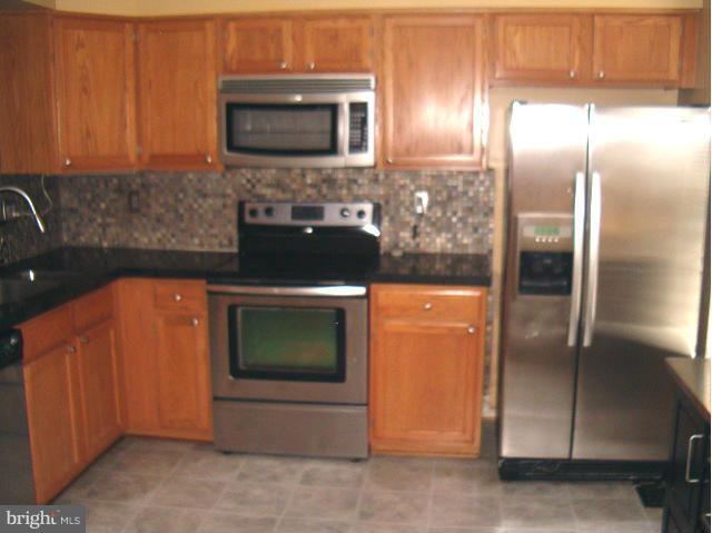 Immaculate and updated 3 bedroom townhouse, move-in ready. Stainless Steel Appliances with Mobile Island, Granite Counter, custom tile back splash with french door to deck.