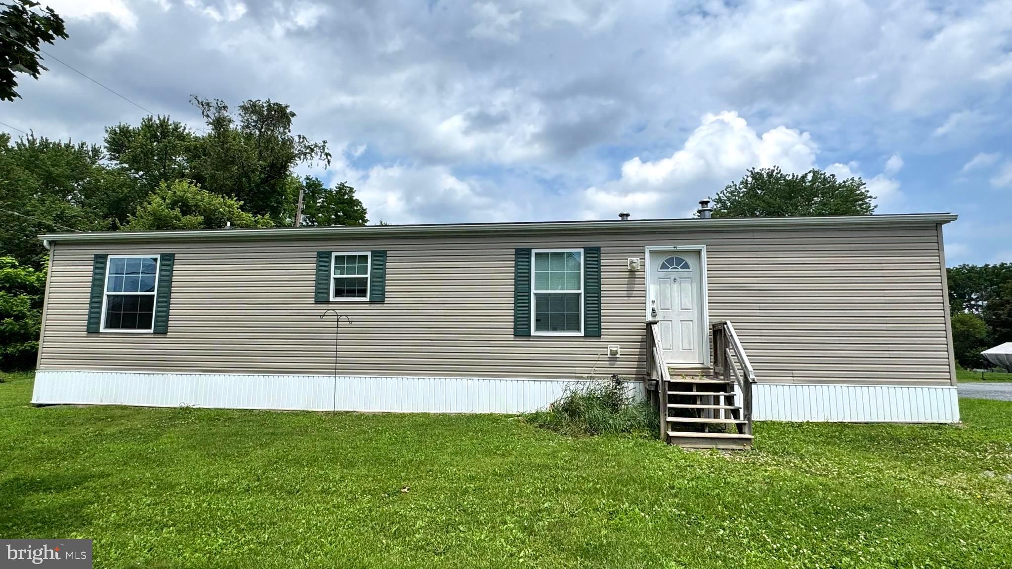 Welcome to this well-maintained 2-bedroom, 1.5-bath mobile home in Middletown offering comfort, space, and affordability. Step inside to find a spacious living room perfect for relaxing or entertaining, and an updated kitchen with modern finishes and ample cabinet space. Both bedrooms feature cozy carpeting, with one offering the convenience of an attached half bath. Enjoy outdoor living with a large front yard—ideal for gardening, gatherings, or simply enjoying the sunshine. Don’t miss this move-in-ready home in a convenient location close to local shops, dining, and major roadways!