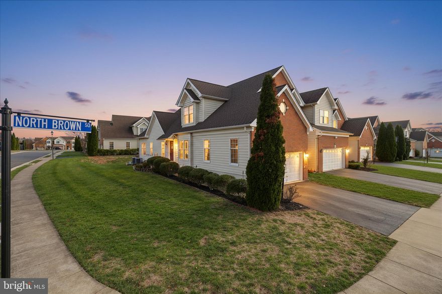 Welcome to this meticulously maintained end-unit Rockland model offering more than 4,000 sq. ft. of refined living space in the highly sought-after Loudoun Valley Estates community. This villa-style carriage home lives like a single-family residence and showcases impressive architectural details, including three-story foyer, soaring cathedral ceilings, and gleaming hardwood floors throughout the main level. The expansive living and family rooms are filled with natural light, anchored by a gas fireplace and enhanced by smart recessed lighting. A beautifully appointed sunroom provides an inviting retreat, while the formal dining room offers an elegant setting for gatherings. The gourmet kitchen is a chef’s dream, featuring cherry cabinetry, granite countertops, stunning backsplash, stainless steel appliances, oven & microwave, a walk-in pantry, and a bright breakfast area with easy access to the two-car garage and customized storage.Upstairs, the luxurious primary suite serves as a private oasis with vaulted ceilings, dual closets with custom shelving, and a spa-inspired bath complete with a granite dual-sink vanity, Jacuzzi tub, stand-alone shower, and heat lamp for added comfort. Two additional spacious bedrooms, also featuring Elfa shelving, share a well-appointed full bath. The fully finished walk-up lower level basement expands the home’s versatility with a large recreation room, ceiling speakers, projector setup, full bathroom, with two walk-in closets of abundant storage, microwave, fridge and mini kitchen. The main level includes a dedicated laundry space complete with a utility sink for added convenience.Outdoor living is equally impressive. A maintenance-free Trex deck with vinyl railings overlooks the lush landscaped yard perfect for relaxing or entertaining. An open area make grilling effortless, while the wide walk-up stairs provide seamless indoor-outdoor flow. Additional home features include a Tesla charger, smart home lighting and thermostats, upgraded fixtures throughout, and a finished garage with epoxy flooring.Residents of Loudoun Valley Estates enjoy access to exceptional amenities, including multiple pools, a fitness center, tot-lots, volleyball and basketball courts, and scenic walking trails all just minutes from the Silver Line Metro, major commuter routes, shopping, dining, and Brambleton Town Center. The HOA covers lawn care and maintenance, allowing you to relax and enjoy the lifestyle. This exceptional home offers an unmatched combination of comfort, sophistication, and lifestyle convenience.