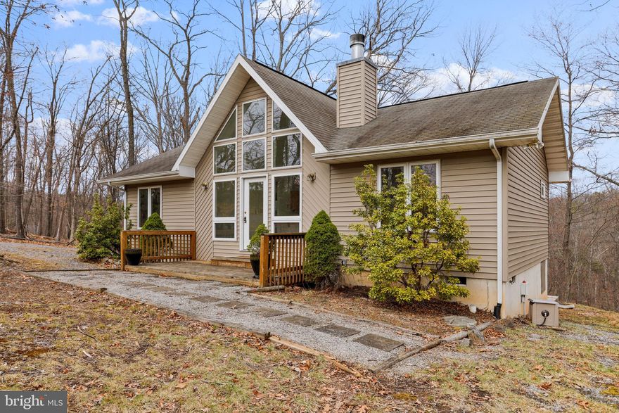 Live on one level in this single family home on one acre. This home boasts a spacious open floor plan, cathedral ceilings, a wood burning fireplace, and a soaring wall of windows to let in all the natural light. The sliding glass doors lead to a 11x12 screened porch, great for enjoying the outdoors. On the exterior, you will find low maintenance vinyl siding, gravel driveway with plenty of parking, and a detached one car garage.
