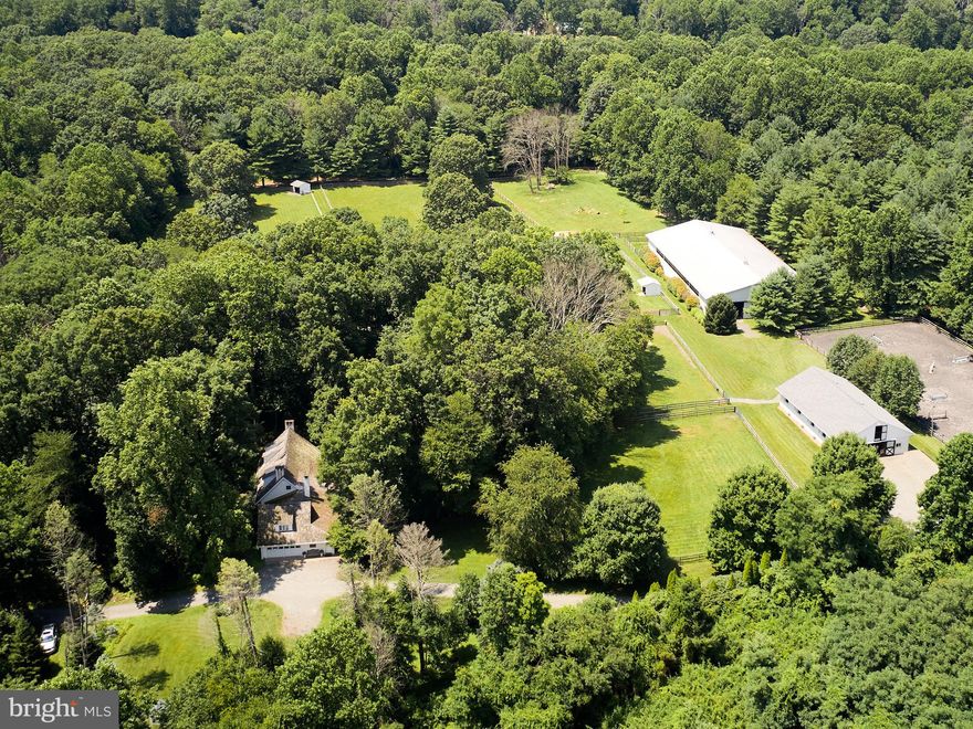 Dreams do come true. Here is an opportunity to purchase this lovely property that over the years the owner thoughtfully  turned it into  a  private equestrian facility. 

The property consists of a home that was originally a brick ranch style house with the main entrance coming through the  finished lower level. Over the years the home was modified to take on the look of an old farmhouse. 

The layout is eclectic yet comfortable and quaint. The footprint was extended and dormers were added to create  two loft areas with separate stairways.  One loft area has a bedroom with a full bath, while the other loft area could be a bedroom but is currently being used as an office with a sitting area. The primary and an additional bedroom are located on the main floor. 

The  owner recently remodeled the kitchen and the three bathrooms    All three  bathrooms and kitchen are done in wonderful neutral tones. Random width hardwood flooring runs through most of the first floor, along with tiled flooring in bathrooms and a laundry room.  A  wide staircase leads you to the finished lower level  with a brick floored foyer, two additional sitting/parlor rooms, one with non-functioning walk-in fireplace the other with a wood burning fireplace  and a powder room completes this floor. 

The house has an attached two car garage as well as a two car detached utility shed by the barn for farm equipment. The house is wired for a portable generator for emergency power. 

Now for the equestrian-
 The property is a total of 9.3 acres on three tax parcels. In addition to the house the owner improved the property by installing a six stall barn (room for seven) with tack room, shower stall, feed room and half bath.  Stalls are approximately 12 x 14. A 195’ x 95’ lighted outdoor riding arena and a 140’ x 75’ indoor riding arena.  Both arenas have a sand, rubber and fiber mixture for footing. Seven paddocks each with their own run-in shed. The whole perimeter of the property is fenced. A lot of thought went into creating this little bit of equestrian heaven! To top it off, you can ride/hike or bike on trails right from the property.

This property is located in the coveted quaint town of Birchrunville. The area is known for its conserved Natural Lands Trust parks with miles of wonderful hiking trails, fine dining and wonderful town and country living. Its location is also convenient to many of the country's top equestrian events and trainers.