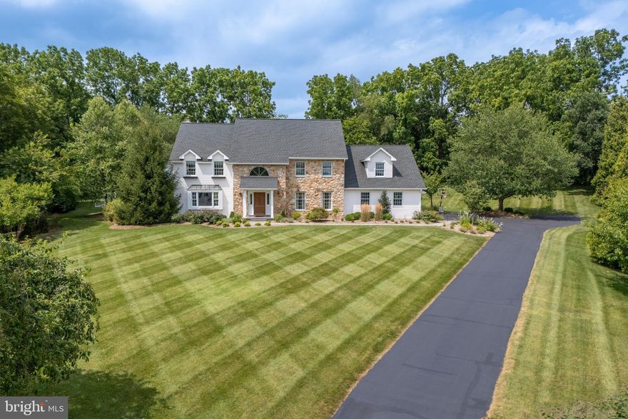 Nestled on a PRIVATE CUL DE SAC in the heart of one of Saucon Valley’s most sought-after neighborhoods, refined craftsmanship meets designer finishes in this elegant 6-BED, 4-BATH home. From the moment you step inside, the COFFERED CEILING foyer, charming PARQUET FLOORING and meticulous design set the tone for what’s to come. The gourmet kitchen features GRANITE COUNTERTOPS, custom cabinets, top-of-the-line appliances, built-in COFFEE STATION, and an OVERSIZED MARBLE ISLAND perfect for entertaining. The kitchen flows seamlessly to the open-concept FAMILY ROOM with FIREPLACE, WET BAR, built-ins and large bay window overlooking the PROFESSIONALLY LANDSCAPED backyard. Relax with a book in the sunken living room with mountain views, and enjoy memorable holiday dinners in the stylish formal dining room. Upstairs, you’ll find similar attention to detail with refinished HARDWOOD throughout, and a PRIMARY SUITE offering serene retreat with freshly renovated SPA-LIKE BATHROOM with MARBLE TILE floors, JETTED SOAKING TUB, and rainfall shower. FIVE ADDITIONAL BEDROOMS provide generous space to comfortably host guests or family. Partially FINISHED BASEMENT offers space for gaming and ping pong, coupled with ample storage area. Outside, enjoy morning coffee or barbecue on the expansive BLUESTONE PATIO among mature trees on the 1.57-acre lot. Other features include whole-house GENERATOR, 3-CAR GARAGE, and convenient location close to downtown Bethlehem, Promenade and I-78.