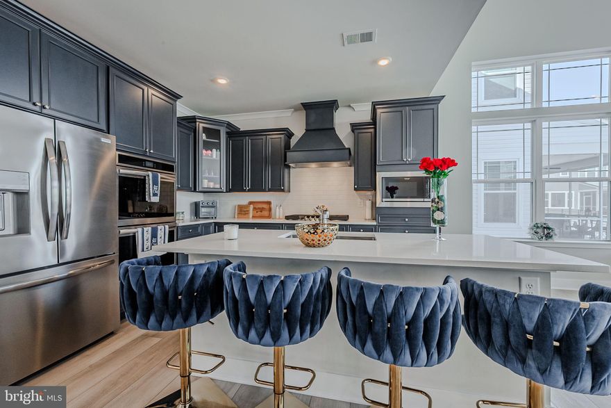 Welcome to 34238 Graham Circle, a luxurious three-bedroom golf benefited home nestled on Graham Circle in the community of Plantation Lakes by Lennar which boasts a first-floor primary suite. This unique home is located in the desirable North Shore Plantation Lakes Community with partial views of the golf course. Upon entering the open foyer, you're welcomed by a bright entryway that flows into a designer kitchen and an open-concept great room. Oversized sliding glass doors guide you to an elegantly designed patio with pristine paving. Complete this retreat with first floor primary suite that encompasses a spa bathroom, built in bench seat, dual sinks and every amenity you could hope for. A full walk in closet and linen closet gives this suite ample storage options.   Upstairs you will find two additional bedrooms with large closets and a loft for socializing and more. 
Nearby within the community you will find the golf course, club house, restaurant, fitness center, outdoor pools and more within a short drive or walk. This stunning home is sure to please anyone looking to have access to the beaches, while living in a quiet friendly neighborhood with amenities abound. Close to the Delaware Beaches