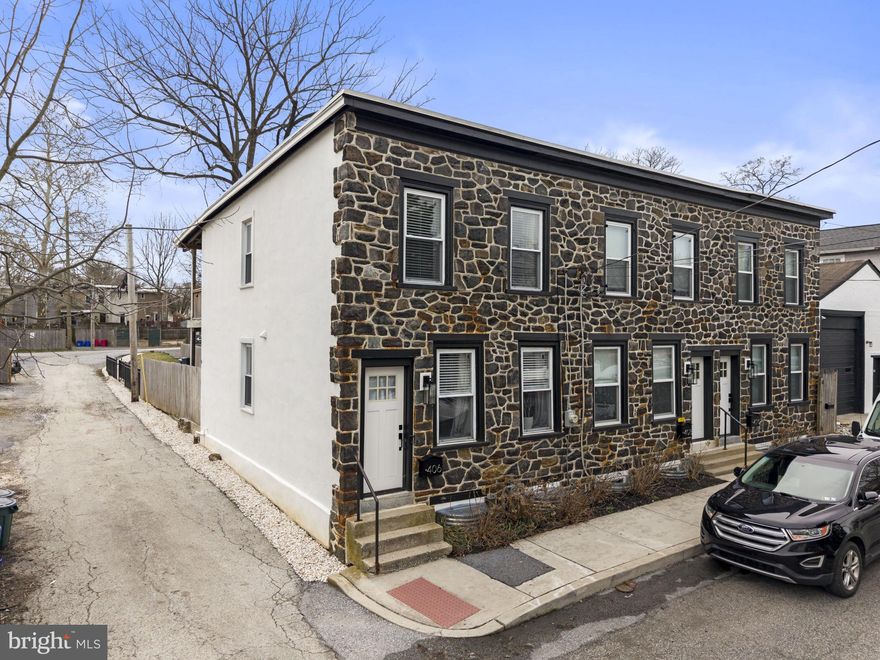 Welcome to 406 W Chestnut Street — a rare opportunity to own a beautifully upgraded historic carriage home in the heart of West Chester Borough, complete with private parking spaces.

This charming 2-bedroom, 1.5-bath end-of-row home seamlessly blends historic character with modern convenience. Inside, you’ll find an open and inviting main level with exposed beams, thoughtfully designed living and dining spaces, and a stylish kitchen featuring functional touches like a built-in charging shelf. An upgraded basement adds valuable flex space, along with a dedicated laundry area and organized storage.

Upstairs, the spacious primary bedroom offers two spacious closets, additional overhead storage, and stunning exposed beams. Just outside, a cozy nook creates the perfect work-from-home setup. The second bedroom is currently configured as an entertainment room with projector capabilities. The full bathroom features a double-sink vanity, and traditional subway tile in the shower, combining style, comfort and practicality.

One of the home’s most exceptional features is the private outdoor space: a beautifully landscaped backyard with a stone patio, grassy area, and a balcony porch that overlooks it all. These balconies are no longer permitted to be built in West Chester, making this a truly unique find. Beyond the yard, you’ll find off-street, gated parking spaces (fits 2 cars, possibly 3 compact cars), an incredibly rare amenity in the Borough. Watch the sunrise right from the balcony or back patio, and enjoy direct sun throughout the day, perfect for a garden or simply catching some spring and summer rays. 

The backyard is also equipped with two extra gas lines ready for a grill, cooktop, or fire pit, along with extended electrical access for a future automated gate system.  No more searching for parking or hauling groceries from blocks away... simply pull in and step right into your home.

Additional upgrades include smart home features such as smart lighting, smart blinds, and a doorbell camera, as well as a $32,000 stormwater management system that directs runoff safely away from the home, providing peace of mind for years to come.

Located just a 2-minute walk from the vibrant center of downtown West Chester and only one block from a favorite local brewery, this home offers the perfect blend of walkability, charm, and modern living.

Don’t miss your chance to own a one-of-a-kind property with private parking, outdoor space, and smart upgrades, all in one of West Chester’s most desirable locations.