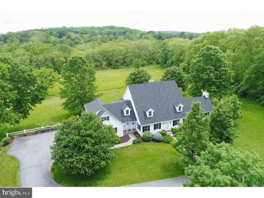 This Bucks County custom home is a classic beauty, further enhanced by a pristine setting along Cooks Creek? a protected, Class A, trout stream.  Nestled off a private road, with a scenic approach through bucolic countryside, you arrive to the middle of a perfectly private eleven acre paradise, where unspoiled vistas of field and stream are your preeminent views.  Abundant wildlife, a canopy of blue skies by day, a profusion of stars at night and meandering trails, creek side, all describe a location few properties can offer. Inside spaces are open, bright, and sophisticated with large rooms that flow effortlessly into each other, boasting rich wood floors.  The first floor has a living room with fireplace, formal dining room, library and an expansive white kitchen with granite and wood countertops, stainless appliances and dining area with fireplace. Adjacent, a stunning great room has a vaulted white board ceiling with cupola, a third fireplace accented with a white board wall, and presents the perfect complement to surrounding vistas through walls of windows.  Most first floor rooms open to a lovely bluestone terrace, competing for your attention to simply relax, read a book or dine alfresco amidst an enchanting backdrop on a sultry summer evening.  Front and back staircases take you to the four generous bedrooms and three baths on the second floor.  Here, the master bedroom suite will both soothe and pamper. This unparalleled location, in Springfield Township, is just 6 miles from Saucon Valley affording dining, shopping and recreational options in every direction, only 90 minutes from NYC and one hour to Philadelphia.