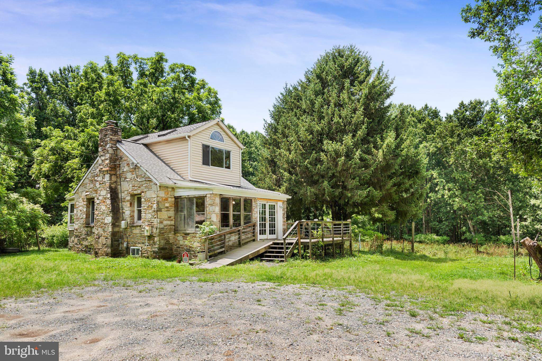 OWNERS ARE OFFERING SELLER FINANCING WITH 50% DOWN AND 0% INTEREST! VERY GENEROUS PRICE ADJUSTMENT! Welcome to this stone cottage oasis on two parcels for nearly 8 acres of woods and farmland! Conveniently located near shopping centers, entertainment, dining and minutes from the Baltimore Beltway. The home has oak floors, cathedral ceilings, jacuzzi bathtub, Anderson doors and windows highlighting spectacular green and private views. The cottage was recently updated with a new roof and gutters. Warranty included. The RC-5 zoning is ideal for a single family dwelling, agritourism, Waldorf or Montessori school, assisted living "class A" or a family farm. One of the outbuildings includes a three-stall horse barn. This unique piece of land also features a stream meandering through the property which is a rare and cherished asset. Don't miss this opportunity to own a sizeable piece of land with endless possibilities. Check out the virtual tour at the top of the listing (click camera icon) for a preview. Schedule your showing today. Bring your imagination and experience the peaceful flow of nature that awaits you!