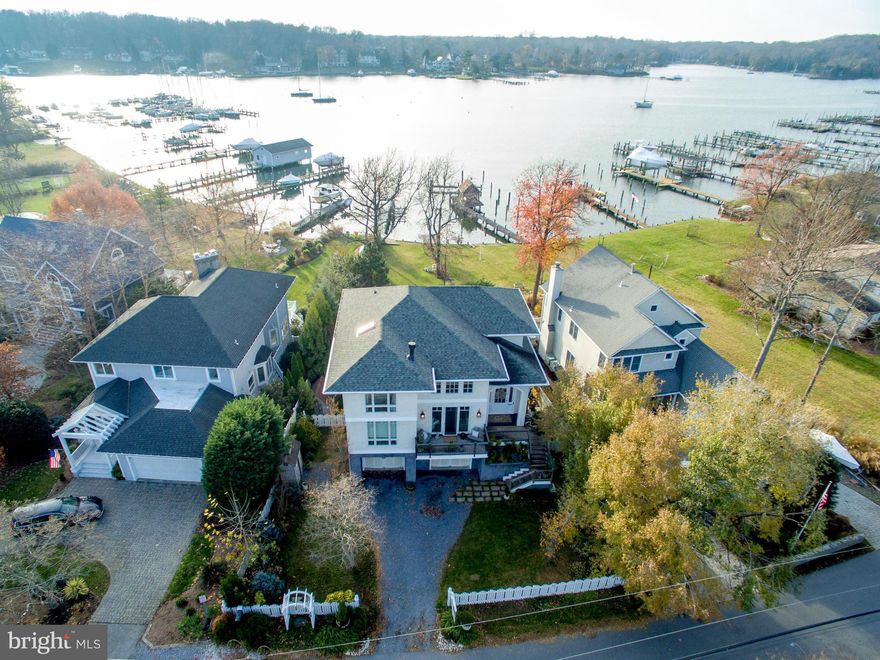 The BEST value for a waterfront property in the neighborhood. Custom-built in 2006 with lush green mature landscaping that lends itself to privacy. The yard leads down to bulk-headed waterfront with a pier and lift, perfectly situated toward the end of the peninsula. Custom fixtures and lighting throughout. View our first person video tour to see what pictures can't show.