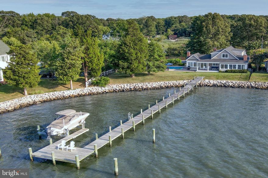 Sited on over 2/3rds of an acre on Wagner's Point, this wonderful residence features waterfrontage on two sides, large pool, pier, and stunning sunrise & sunset views across the West River.  The main level offers an open sunbathed floorplan with hardwood floors, gourmet kitchen with island & stainless-steel appliances, family room with wood burning fireplace, dining area, primary suite with luxurious bathroom, 2 additional bedrooms and a bathroom.  A porch off the family room and primary suite is a perfect place to sit back and enjoy the boats passing by.   The second level offers 2 additional bedrooms, a full bathroom, and laundry.  Originally 3 parcels, this extra wide lot offers expansive views across the West River and towards the Bay Bridge, ample outdoor space, and a large pool with spa & pool house.  The pool house offers a powder room and storage/mechanical closet.  A private dock with boat lift is the perfect place to enjoy the views and all of your activities on the bay.  An additional pier on the Cedar Creek side is perfect for fishing, canoeing or kayaking.  A oversized storage shed and parking for 6+ cars complete this offering.  Perfect for either full time residence or a weekend home. Less than 45 minutes from downtown DC and 30 minutes to Annapolis.   A rare opportunity to own a truly special waterfront property in Shady Side!