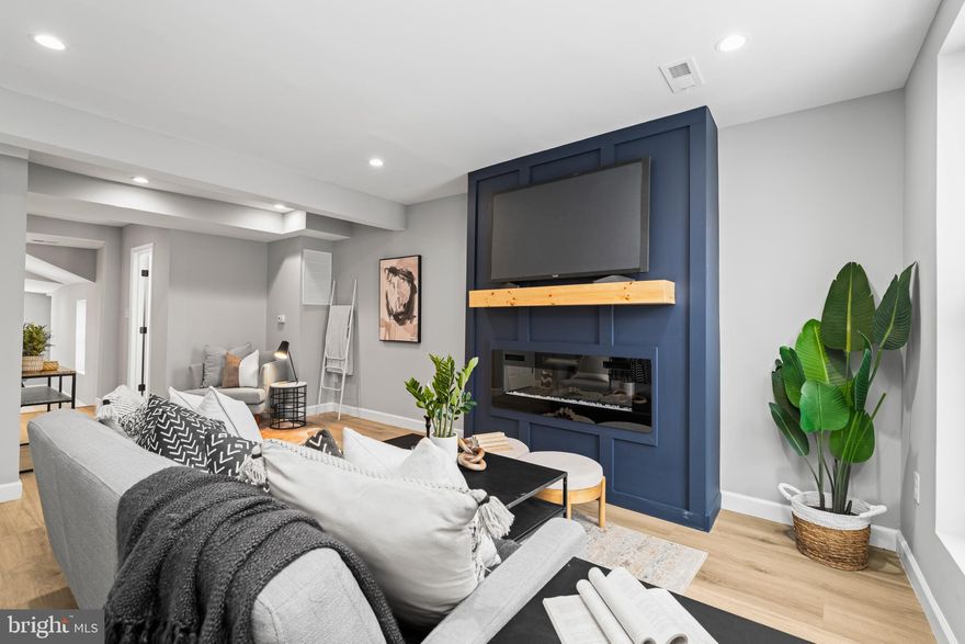 Welcome to 897 W Lombard St. This updated 3-level brick townhome in Hollins Market boasts 4 bedrooms and 3.5 baths. Upon entering, you'll find gorgeous LVP flooring across the main level and plentiful natural light. The living room, featuring an electric fireplace accent wall, flows into the modern kitchen, equipped with new white cabinets, quartz countertops, stainless steel appliances, and a tile backsplash. All bathrooms feature high-end finishes. The second level hosts 2 bedrooms and a full bathroom, while the third level includes 2 additional bedrooms and another full bathroom. The lower level provides versatile space for a home office, gym, family room, or extra guest bedroom, complemented by another full bathroom. The private, fully fenced backyard enhances outdoor living. Situated in a lively neighborhood, it’s close to major highways 295 and 95, downtown, local stadiums, the University of Maryland, Hollins Market, and Union Square. 1 year Home Warranty Included!