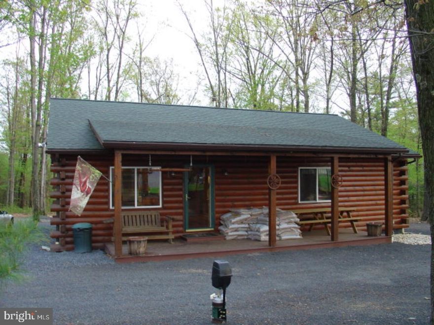 Charming log home on 1 acre wooded lot with brick BBQ area. Large deck, beautiful view of Second Mountain from kitchen/dining rm, full basement & stand up attic. Pellet stove in LR.  Mortgage is a floating loan Mailing Address Continued: Pine Grove Color: log Amp: 200