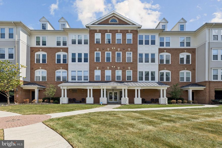 ** PRICE IMPROVEMENT**
Spacious and well-maintained 2 bedrooms, 2 bathrooms with separate den/office space.  Located in the Premier K Hovnanian's Four Seasons 55+ active adult community in Ashburn Village, this 1,765 sq ft Brockton model condo is ready for a new owner. 
Providing a warm and inviting feeling to this home are the brand new hardwood floors throughout the formal dining room, living room, sun room, and kitchen areas. The kitchen has also been recently updated with new granite countertops and backsplash. Beautiful crown molding, columns and chair rails provide an added elegant touch to the formal dining room.  The large living room flows into the sun room, which flows through to the breakfast room and kitchen. The separate den space as you enter the condo is perfect to unwind with a good book, or an ideal spot for a home office, or additional seating.
The bedrooms and bathrooms are located on each side of the condo. The spacious private primary bedroom suite has lots of natural light and includes a large walk-in closet with a beautiful spa bathroom that has a separate shower and soaking bathtub.  Across the main living space is the 2nd light filled bedroom, 2nd full bathroom, coat closet and laundry room. 
This condo is move-in ready with over $50K in upgrades: Hardwood floors - 2025, New windows & blinds - 2024, Kitchen granite countertops and backsplash - 2024, Fresh paint - 2024, HVAC - 2022, Primary bathroom - 2021, Newer stainless steel kitchen appliances.
Enjoy the quiet onsite Community Clubhouse with a workout facility, space for private events and meetings, and a patio picnic/BBQ area with a gazebo.  As part of Ashburn Village HOA, you can also enjoy all the amenities that Ashburn Village has to offer, such as the Sports Pavilion, pools, tennis courts, 8 lakes/ ponds, and 50 miles of jogging/walking and bike trails.  
The secure building offers key fob entry, exterior security cameras and intercom entrance - providing security for all residents. This unit includes an assigned parking spot in the covered garage and a storage space on the garage level. 
Location is EVERYTHING! The Four Seasons Community is within walking distance to the Loudoun Senior Center, and within a few miles to Shops, Restaurants, Library, One Loudoun Shopping Center, Dulles Town Center Mall, Loudoun Hospital and Dulles International Airport.