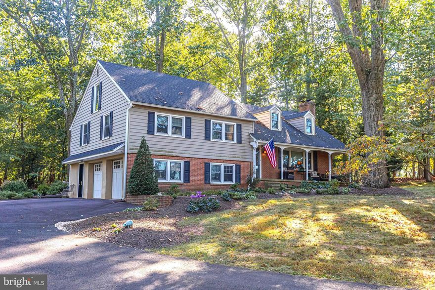 Nestled on a picturesque 1.6-acre lot in desirable Upper Gwynedd Township, this beautifully maintained 4-bedroom, 3 full-bath home showcases exceptional pride of ownership throughout. Tucked back from the road and surrounded by mature trees and professional landscaping, the property offers the perfect blend of privacy, charm, and functionality. An expansive driveway leads to the oversized 2-car garage, while the covered front porch provides a welcoming place to relax and enjoy the peaceful setting. Timeless curb appeal shines through with the classic brick façade, dormer accents, and manicured grounds. Step inside to a warm and inviting foyer that flows seamlessly into the spacious living room, ideal for both everyday living and entertaining. Filled with natural light, the living area features a stunning wood-burning fireplace with a classic wood mantel and elegant soapstone surround, along with custom built-ins and charming architectural details. The beautifully remodeled kitchen and dining area blend warmth and timeless design. Renovated with custom cabinetry by Village Cabinetry, the space features soapstone countertops, recessed lighting, abundant storage, and a large butcher block island with built-in oven. A farmhouse-style stainless steel sink overlooks the scenic backyard, while a skylight fills the space with natural light. Sliding glass doors lead directly to the private outdoor retreat. Designed for relaxation and entertaining, the backyard oasis features a newer custom deck built by Supreme Dream Contracting complete with lighting and power, along with a beautifully designed bluestone patio with a french drain system. Multiple seating areas create the perfect setting for summer BBQs, outdoor dining, or simply unwinding while enjoying peaceful wooded views and watching deer stroll by. Heading back inside to the second level, the spacious primary suite offers a peaceful retreat with soaring vaulted ceilings, exposed beams, skylights, and abundant natural light. The beautifully updated en-suite bath showcases a sleek modern design complete with a glass-enclosed walk-in shower, elegant tilework, contemporary vanity, and spa-like finishes. Two additional generously sized bedrooms offer flexible living arrangements, with one currently utilized as a home office. A beautifully updated full hall bath serves both bedrooms. Continuing to the upper level, you’ll find an expansive fourth bedroom offering incredible flexibility as a guest suite, bonus room, playroom, home gym, or additional living space. The finished lower level provides the perfect extension of the home’s entertaining space with a spacious recreation room, stylish bar area with beverage refrigerators, and warm inviting finishes throughout. A beautifully updated full bath features a tiled walk-in shower accented with handcrafted Moravian Tile Works details. Completing this level is a generous laundry/mud room with direct outdoor access and entry to the oversized two-car garage with newer insulated garage doors. Additional highlights include 2-zone central air, replacement windows 2008, newer siding, roof replaced in 2014, Pella doors installed in 2020, and a waterproofed basement. Thoughtfully updated throughout, this move-in ready home is conveniently located near restaurants, parks, shopping, and major commuting routes, offering the perfect combination of comfort, convenience, and lifestyle.