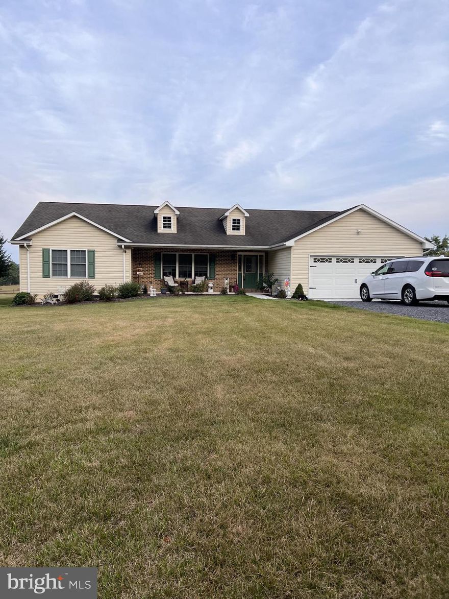 This beautiful home on 6 acres in the countryside with a small pond definitely offers a peaceful and serene environment. The 3-bedroom, 2-bath layout with an open floor plan provides ample space for comfortable living. The combined kitchen, living room, and dining room area of 27x29 feet offers a spacious and connected living space.  New counter tops and appliances within the past year.  
2-car attached garage and a 2-car detached garage is great for parking and additional storage. The two outbuildings, sized at 10x16 and 8x10, could serve various purposes such as storage, workshops, or hobby spaces. A fenced yard adds privacy and security, making it an ideal space for pets or outdoor activities.
Having a front porch is a charming touch, creating a welcoming entrance and a place to enjoy the outdoors. The peach trees on the property add natural beauty and could provide delicious fruit when in season.
The combination of a spacious layout, attractive features like the small pond, outbuildings, garages and fenced yard, along with beautiful views, creates a property with a lot of potential for a comfortable and enjoyable country living experience. This is a must see! Refrigerator, washer, dryer, playset and dog kennel do not convey.  Chicken coops possibly can stay.