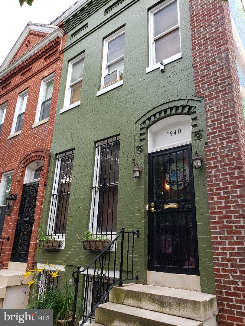 **ESTATE SALE!**
Welcome to 1940 Druid Hill Avenue, an end-of-group townhome in the heart of historic Druid Heights—just blocks from Reservoir Hill, Marble Hill, and the Maryland Zoo. This is not just a home; it’s a canvas for restoration. Nestled beside a green space and beneath a vibrant community mural, you’ll find a reflection of the neighborhood’s spirit—kindness, care, and connection. The outdoor dry pantry and book nook still stand as a tribute to that vision.
Featuring a classic brick façade and iconic Baltimore marble steps, this property offers timeless architectural charm waiting to be revived. Inside, the traditional floor plan includes a spacious living room, a formal dining room with a stunning beveled lead glass skylight, and a kitchen with a rear extension that could serve as a mudroom, pantry, or laundry area.
Upstairs, you’ll find three private bedrooms and a full bath. The full-height basement offers plenty of room for storage or additional living space. While the home needs restoration and is being sold strictly *as-is*, the bones are good, and the potential is immense.
Moments from I-83 and downtown Baltimore, and surrounded by some of the city’s most historic and culturally rich neighborhoods, this property invites you to be a part of the *B-more Charm City* movement. Restore the past, and build the future—right here on Druid Hill Avenue.
