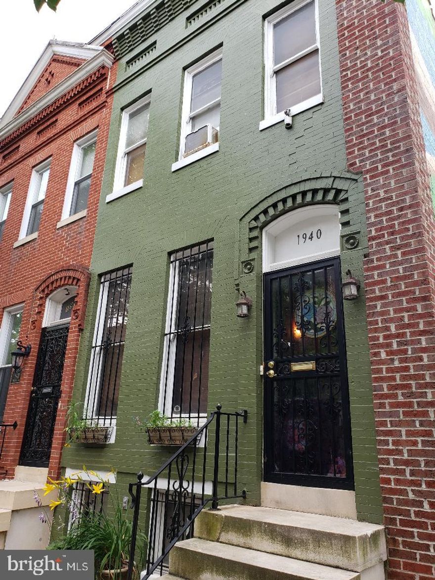 **ESTATE SALE!**
Welcome to 1940 Druid Hill Avenue, an end-of-group townhome in the heart of historic Druid Heights—just blocks from Reservoir Hill, Marble Hill, and the Maryland Zoo. This is not just a home; it’s a canvas for restoration. Nestled beside a green space and beneath a vibrant community mural, you’ll find a reflection of the neighborhood’s spirit—kindness, care, and connection. The outdoor dry pantry and book nook still stand as a tribute to that vision.

Featuring a classic brick façade and iconic Baltimore marble steps, this property offers timeless architectural charm waiting to be revived. Inside, the traditional floor plan includes a spacious living room, a formal dining room with a stunning beveled lead glass skylight, and a kitchen with a rear extension that could serve as a mudroom, pantry, or laundry area.
Upstairs, you’ll find three private bedrooms and a full bath. The full-height basement offers plenty of room for storage or additional living space. While the home needs restoration and is being sold strictly *as-is*, the bones are good, and the potential is immense.
Moments from I-83 and downtown Baltimore, and surrounded by some of the city’s most historic and culturally rich neighborhoods, this property invites you to be a part of the *B-more Charm City* movement. Restore the past, and build the future—right here on Druid Hill Avenue.
