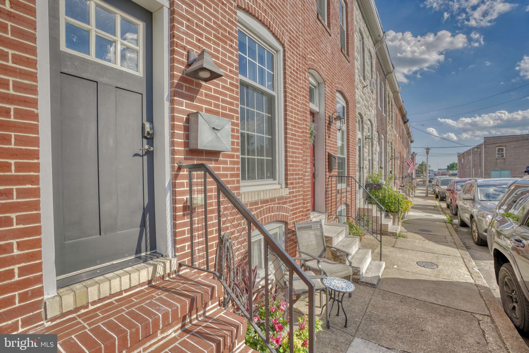 Wonderful rowhome in Locust Point! This lovely home features 2/3 bedrooms, 2 full baths, wood floors, an open layout, gourmet kitchen, breakfast bar and sitting area, new paint, finished basement, 3rd floor front deck for CITY VIEWS! Walk right into warm and inviting home that has a perfect 1st floor level for hanging out and entertaining, gourmet kitchen has granite counters, breakfast bar and island, rear sitting room, front dining room and office set up, open staircase with 2nd floor foyer area that can be used as a sitting room, etc. 2nd floor boasts two good sized bedrooms and 1 full bath in hallway. 3rd floor can be a recreational room or used as a 3rd bedroom with washer/dryer and walk-in open closet area and luxury full bath with skylight and access to deck from the front sliders. 3rd floor has separate HVAC system. Partially finished basement with sitting area and extra storage. Make this your new DREAM HOME NOW and start LIVING the CITY LIFE! Over 1600 of above grade LIVING SPACE!