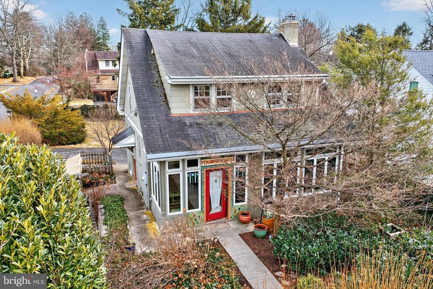 Welcome to this extraordinary Arts and Crafts–style residence, built in 1928, thoughtfully situated in the heart of Doylestown Borough and within the esteemed Central Bucks School District. Rich in architectural integrity and enduring appeal, this 3 bedroom, 1.5 bath home reflects the craftsmanship, proportion, and material honesty that define the American Arts and Crafts movement, while also offering the opportunity for selective personal updates to suit today’s lifestyle. A custom tiled house address above the entry door offers an early hint of the artistry found throughout. Inside, unpainted chestnut millwork, oak floors, and leaded glass windows speak to a design ethos rooted in natural materials and human scale—principles championed by Frank Lloyd Wright and his contemporaries, and expressed here with authenticity and restraint. A beautifully tiled, heated sunroom creates a graceful transition into the living room. This inviting space is anchored by a fireplace with a Moravian tile surround, flanked by leaded glass windows that draw in natural light. The dining room is bright and welcoming, well-suited for both daily living and entertaining. Nearby, the efficient U-shaped kitchen offers great functionality and presents an excellent canvas for thoughtful customization, opening to a charming office or breakfast room featuring a bay window and exposed brick wall. A finely crafted staircase and banister ascend to the second floor, where 3 well-proportioned bedrooms feature deep closets, complemented by a walk-in hall closet. The updated bathroom is finished with a bespoke tumbled stone floor, laid in a timeless piazza-style pattern and includes a soaking tub, blending period-appropriate style with modern comfort. The finished lower level extends the living space with limestone flooring, a cedar closet, a garden bathroom, and walk-out doors to the rear grounds. An attic with abundant storage and potential for future expansion adds further flexibility. Outdoors, the property is framed by mature specimen trees and layered plantings that provide natural privacy and seasonal interest. A pergola-covered paver patio, custom fencing, a deep backyard with a screened refuse area, a cedar playhouse, and a stone sitting area in the front yard create multiple outdoor environments for relaxation and enjoyment. Warm, grounded, and architecturally resonant, this home offers a rare opportunity to honor its historic character while making it distinctly your own in Doylestown Borough.