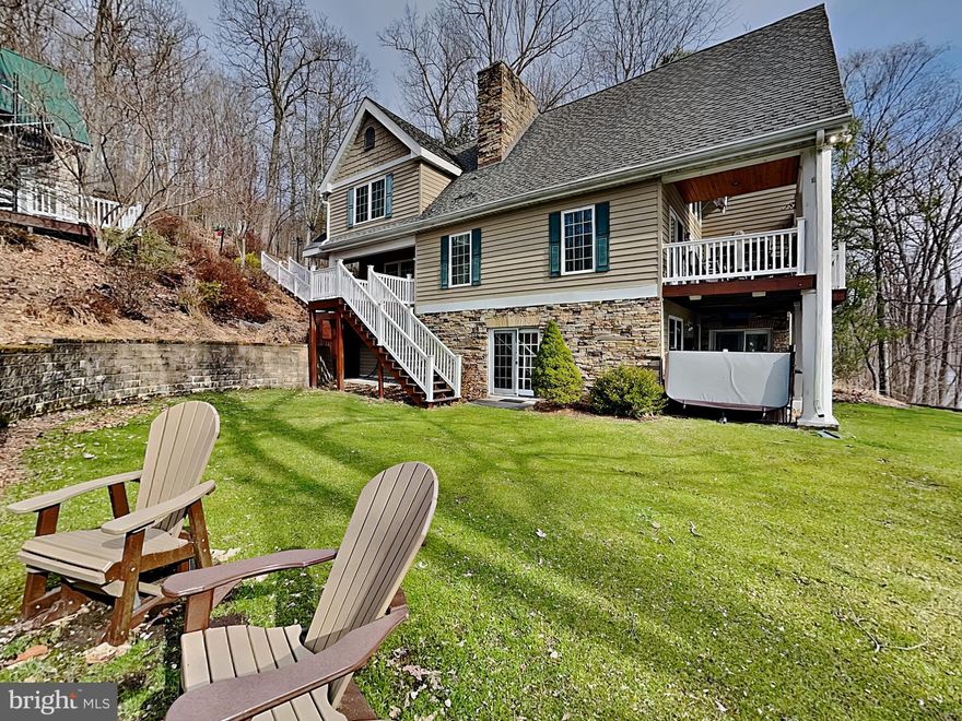 5BR, 4BA custom lakefront home with additional carriage house above detached garage. Carriage house currently setup as a game room with kitchenette and pullout couch; this has served as a 5th BR prior to renting. Features include high end furnishings, gourmet kitchen, picturesque fireplace, flat lawn for yard games, built in fire pit,  observation deck, EV charger and high efficiency heating and cooling systems. You will love the privacy of the Shingle Camp Rd area yet its close proximity to Wisp, Lodestone & Fantasy Valley golf courses. NO HOA - county maintained roads. Private type A dock in a deep water area of the lake with storage shed for lake toys & fishing gear. Fun 'Midway tiki bar' and 'Luv Shack' built-ins by the water. Covered lakefront porch allows for plenty of time outdoors. Established vacation rental 'A Lakefront Paradise'.