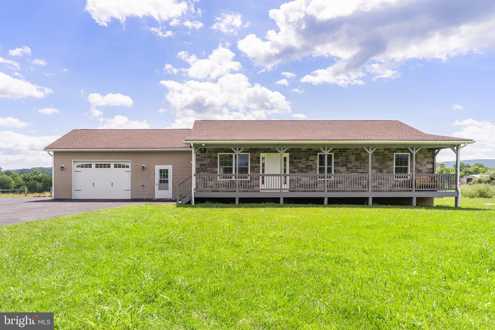 Bring your dream home business or homestead to life on this nearly 20-acre property with no HOA, tucked away on a private lane for added peace and privacy. The charming 3-bedroom, 2.5-bath stone ranch-style home offers one-level living with a welcoming front porch, a screened-in sunroom overlooking the inground pool, and an attached garage with a bonus room perfect for relaxing or entertaining.
Inside, the kitchen features gas cooking and a dedicated dining area, while the family room is anchored by a beautiful stone gas fireplace—creating a warm and inviting space to gather. The primary suite includes chair rail detailing, a spacious closet, and an en-suite bath. Two additional bedrooms are nicely sized, and the laundry is conveniently located in the half bath.
Three out of four fields are already fenced, and the land is currently in farm use—ready for your animals, agriculture, or entrepreneurial vision. Outbuildings include a 60 x 30 workshop complete with an office and a separate HVAC system for year-round comfort, offering potential for an in-law suite or business use. There's also a detached two-bay garage with an attached storage barn, a 12 x 20 wooden shed with a 9' door, electric, and 12" runner joists, and a one-stall barn (10 x 11) with a feed room and fenced paddock—formerly home to goats.
With so much space, functionality, and flexibility, this property offers the freedom to start a homestead, hobby farm, or whatever your heart desires.