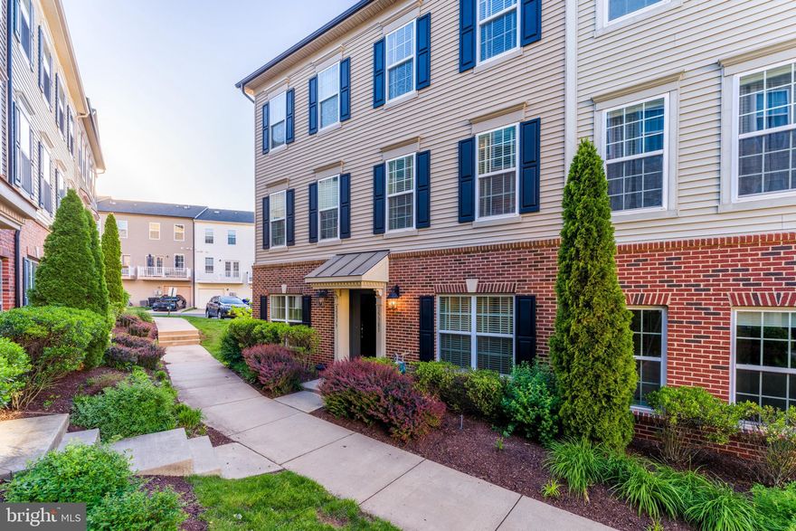 Welcome to 15381 Rosemont Manor Drive — a beautifully maintained condo-style townhouse nestled in the highly desirable Market Center community of Haymarket. Offering nearly 1,900 square feet of living space across three finished levels, this move-in-ready home combines comfort, style, and modern convenience. The entry level welcomes you with a spacious foyer leading to a versatile first-floor bedroom filled with natural light and generous closet space — ideal for guests, a home office, gym, or additional living area. This level also features a full bathroom with updated hardware and access to the rear-loading one-car garage with added storage space. Upstairs, the main living level showcases an open-concept layout with rich hardwood floors, a bright and inviting family room, and a convenient powder room. The expansive center-island kitchen is designed for both everyday living and entertaining, featuring granite countertops, stainless steel appliances, a custom tile backsplash, and ample dining space. Step outside to the private balcony — perfect for enjoying morning coffee or relaxing at the end of the day. The upper level includes a spacious secondary en-suite bedroom with its own private bath, a laundry closet, and a luxurious owner’s suite complete with a large walk-in closet, and a spa-inspired bathroom featuring double vanities, and a spacious shower. Recent updates and smart-home enhancements add even more value, including fresh interior paint (2026), newer washer (2023), updated kitchen blinds (2023), a brand-new garage door opener (2025), updated lighting fixtures (2024), an Ecobee smart thermostat, Eufy video doorbell, and a smart ceiling fan in the primary suite. The monthly condo fee covers water, trash service, roof and exterior maintenance, snow removal, and access to exceptional community amenities including a clubhouse, swimming pool, playgrounds, and picnic areas — offering truly low-maintenance living. Perfectly situated directly across from UVA Medical Center and just minutes from I-66, Route 29, and Route 15, this home offers unbeatable commuter convenience with easy access to Downtown Haymarket, Gainesville, shopping, dining, and entertainment.