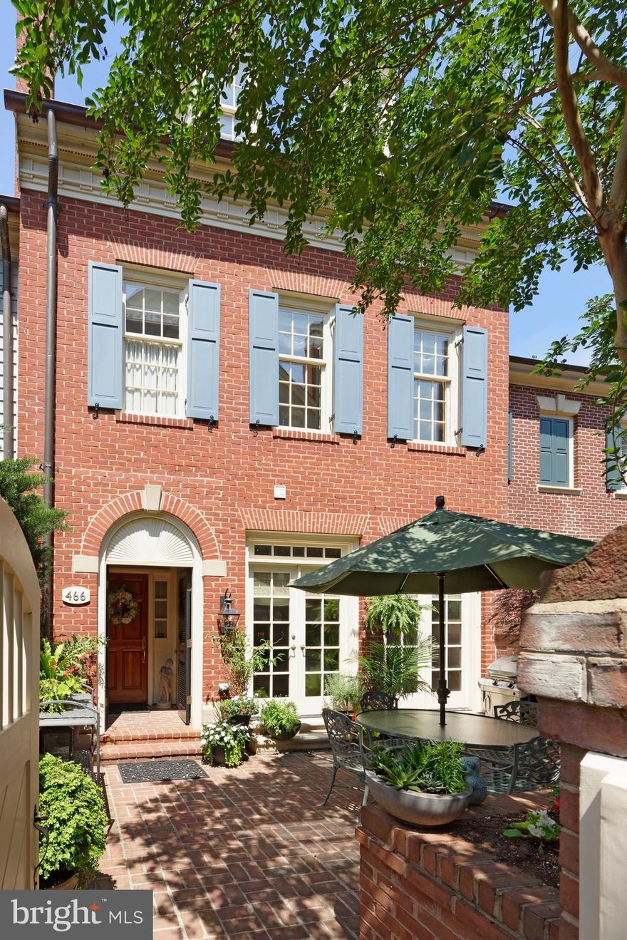 The best of classicism and modernism harmonize beautifully in this impeccably renovated, finely appointed 3 bedroom, 3.2 bath home in the exclusive waterfront community of Harborside, set in the heart of desirable Old Town. No detail or expense was spared in the extensive, meticulous inside-out remodel of this charming brick gem boasting convenient 2-car garage parking, an interior elevator with wood & mirrored panels, magnificent millwork, wide arched openings, custom cabinetry & built-ins, and top-of-the-line everything throughout.   Among the upscale highlights are dark refinished oak wood floors, brass door knobs & hinges, new recessed lighting & fixtures, and quality European paints in soothing color tones enriching the ambience. A formal entry hall with wainscoting, grand staircase and checkered marble floors welcomes your arrival and introduces incredible elegance. Glass French doors open to a private office with custom built-in bookcases, cabinetry & TV. Step out through 2 pairs of French doors to a lovely professionally landscaped patio with mature trees for reading, relaxing and entertaining. Host guests in the stunning light-filled living room featuring floor-to-ceiling windows adorned with designer Schumacher window treatments & linen shades, a gas fireplace flanked by arched custom bookcases, fabulous coffered ceiling, and wet bar with copper sink for serving cocktails. Shift into the regal wainscoted dining room with silk window valances to enjoy formal sit-down meals. Living and dining room windows are covered with UV film to protect the fabric coverings from the sun. The new custom kitchen is a culinary showplace styled with gleaming marble-like granite countertops in a rare color, and premium-grade Wolf, Sub-Zero & Bosch appliances for the chef. Sip your morning coffee in the open breakfast area with custom built-ins brightened by an oversized window. All bathrooms in the home, from the first & second-floor powder rooms to the 3 full baths on level 2, 3 & 4 were completely redone to the highest standard. The luxurious master bath is clad in marble, with all new plumbing, lighting & ceiling fans affording a spa experience. Refresh & renew in your divine master bedroom with a fireplace and custom walk-in closet for your belongings. Additional bedrooms are generously-sized with ample closets for the comfort of family & guests. Other enhancements include a newer roof & cooper gutters, Carrier gas furnace & AC, tank-less water heater, central vacuum and Sonos audio system. Heightening the allure of this very special Old Town residence is its prized location near the Potomac River, parks, restaurants and conveniences.  Enjoy the virtual tour: https://tours.linenandlens.com/1622671?idx=1