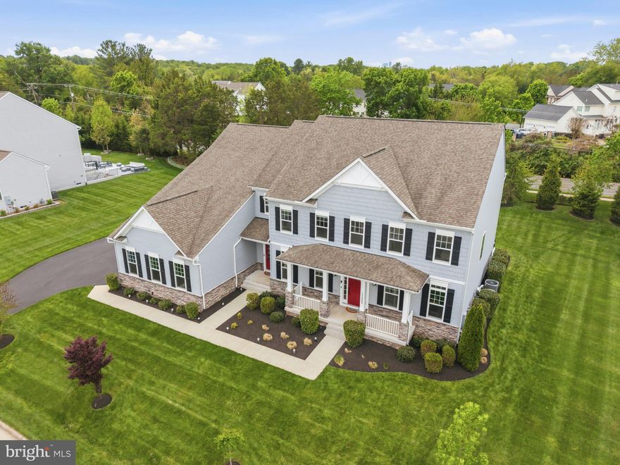 Situated on a premier 0.57-acre cul-de-sac lot, this 2019-built estate offers an unparalleled living experience spanning over 8,100 square feet of meticulously designed space. The residence makes an immediate impression with its commanding Colonial silhouette and side-load three-car garage, opening into a gallery-inspired interior defined by light oak wide-plank flooring, matte black accents, and soaring ceilings. The heart of the home is the great room, where a floor-to-ceiling black marble fireplace serves as a stunning focal point, framed by a wall of windows that flood the home with natural light and invite the outdoors in. The kitchen is a masterclass in contemporary design, equipped with sleek cabinetry, premium quartz countertops, and a massive waterfall island that transitions seamlessly into the open-concept living areas. Designed for the modern lifestyle, the main level includes a versatile guest suite with a full ensuite bath, ideal for visitors. Upstairs, the primary sanctuary serves as a true retreat, boasting a spa-inspired bath with a freestanding soaking tub, a seamless glass shower, and dual designer vanities. Every secondary bedroom is a private oasis, each thoughtfully paired with its own beautifully appointed ensuite bathroom to ensure comfort for family and guests alike. The home’s lifestyle potential extends to the expansive walk-up lower level, a versatile space perfectly suited for a state-of-the-art home theater, private gym, or recreation space and ability to finish space for an additional 6th legal bedroom.  The double-wide doors invite an abundance of natural light into the space. Outside, the flat backyard opens to a deck with custom lighting and offers a rare level of privacy and a blank canvas for a custom pool, pavilion, or outdoor kitchen. Meticulously maintained and featuring high-end upgrades such as a comprehensive water treatment system and sprinkler system, this property offers the peace of mind of recent construction. Located just minutes from the Silver Line Metro, Reston Town Center, and the Dulles tech corridor, this is a rare opportunity to own a modern masterpiece in the heart of Herndon’s most sought-after landscape.