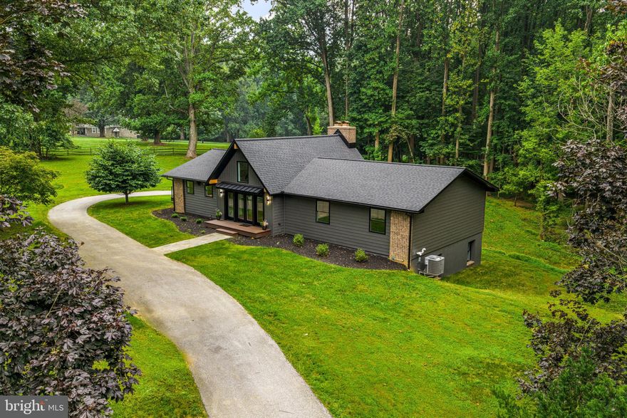 Discover modern design, natural beauty, and timeless comfort at 615 Cricklewood Road — a fully renovated, contemporary home nestled on 1.8 private acres in one of Chester County’s most peaceful, no-thru-traffic neighborhoods. With low taxes, better-than-new construction, and effortless one-floor living, this exceptional residence is ideal for those seeking serenity without sacrificing proximity to Glen Mills health centers, premier golf courses, and Routes 202, 1, and 322 to Wilmington and Center City.

Every inch of this home has been thoughtfully reimagined with both form and function in mind. Step inside to soaring ceilings, warm white oak flooring, and beautiful exposed wood beams that add character. The bright and welcoming foyer leads to a stunning open-concept kitchen featuring abundant storage, an oversized island with statement countertops, and sophisticated finishes throughout. The adjacent dining area flows seamlessly to a spacious deck with tranquil wooded views — the perfect backdrop for morning coffee or evening entertaining.

The expansive, partially fenced yard offers endless possibilities for outdoor living, from hosting gatherings and enjoying yard games to creating a cozy firepit area for relaxing under the stars. The main level offers three well-appointed bedrooms and 2.5 baths, including a luxurious primary suite complete with expanded en-suite bathroom and private deck access for peaceful moments surrounded by nature. Design-forward elements include sleek new two-panel doors, designer lighting, stylish tilework, and all-new HVAC, electrical, windows, roof, siding, and plumbing systems — delivering true move-in-ready peace of mind.

The fully finished lower level offers two additional bedrooms, a full bath, and a second living area anchored by a cozy fireplace — ideal for extended family, guests, or flexible living arrangements. A spacious laundry room, two-car garage with an attached storage area, and a 16x20 outdoor shed provide practical conveniences, while the attic offers potential for additional storage if desired.

With its combination of space, privacy, thoughtful upgrades, and unmatched pricing, this opportunity stands out as one of the best values on the market — there’s truly nothing else like it. Skip the wait for new construction and step into a beautifully curated home that feels secluded yet connected to everything that matters.