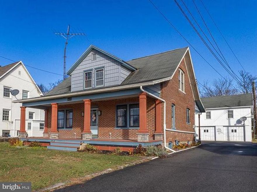 Charming brick home with an independent apartment above the detached garage. This Cape Cod welcomes you with an inviting front porch, hardwood floors throughout the main level, living room, dining room with a built-in cabinet, and a remodeled kitchen featuring Carrera marble counters and tile backsplash and 'Cafe' line stainless appliances. One bedroom and a full bath complete the first level.  The second floor offers hardwood flooring,  two more bedrooms with generous closet space, attic access, and a second full bath with Carrera marble floors and walls. The two-car detached garage comes with a comfortable apartment above featuring laundry,  kitchen, living/dining combo, 1 bedroom with closet and door to deck, 1 bath, and the walk-up attic could be finished for additional living space.  Other highlights include an unfinished basement in the main house,  a rear porch, and shed. This property has a cistern and public sewer.