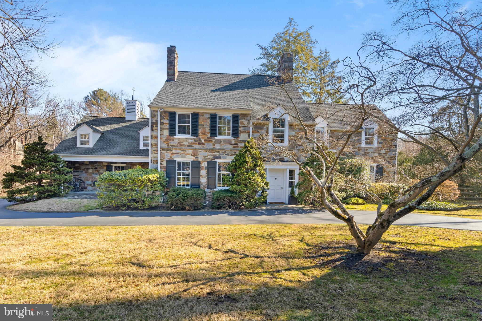 This STUNNING classic stone colonial sits on almost two acres on one of the most beautiful tree lined streets in Lower Merion. The house has a large Entrance Hall, 4 fireplaces, and a grand staircase. Hardwood floors carry you from room to room creating a natural flow that is perfect for all of your entertaining needs. The formal Living and Dining Rooms are large and bright and boast many beautiful features including deep window sills and crown molding throughout. Straight through the Foyer is a charming Den leading directly to an enclosed porch and flagstone patio. Enter into the Kitchen, and you are greeted with white custom cabinets and modern appliances. The Kitchen opens directly into a Family Room that was added by the current owners. This room has big windows that provide a stunning view of the backyard, and French doors that lead to the flagstone patio. There is also an attached two-car Garage with an entrance into the Kitchen. The second floor boasts a large Master Bedroom as well as five additional Bedrooms. The Master has an updated en-suite Bathroom, large closets, and a deck that overlooks the backyard. The five additional Bedrooms include 3 add'l Bathrooms, one being a completely renovated "Jack and Jill" Bathroom. The two Bedrooms in the back of the second floor have have a full Bath and their own staircase leading to the Kitchen. They would be perfect for an Au Pair or In Law suite! There is a fully finished, climate controlled Play Room / TV area on the third floor. The room has hardwood floors, a spacious cedar closet and lots of natural sunlight. The Lower Level of the home is expansive. It includes laundry, storage areas, a temperature controlled wine cellar and recreation room . Plus there is a generator. The basement can be easily finished for additional living space. This property is a Main Line buyer's dream! Please don't miss the chance to see this beautiful home. Virtual Tour with Matterport, photos, & floor plans: