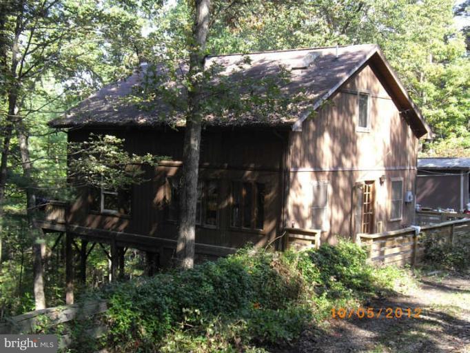 Chalet in wooded setting with views from wrap around deck and floor to ceiling windows. Open floor plan kitchen/LR/Dining with loft above. Large kitchen island with whirlpool tub in main floor bath, recessed lighting, skylights, separate laundry, just 20 min. from I 81. Meas are approx., done by radar.